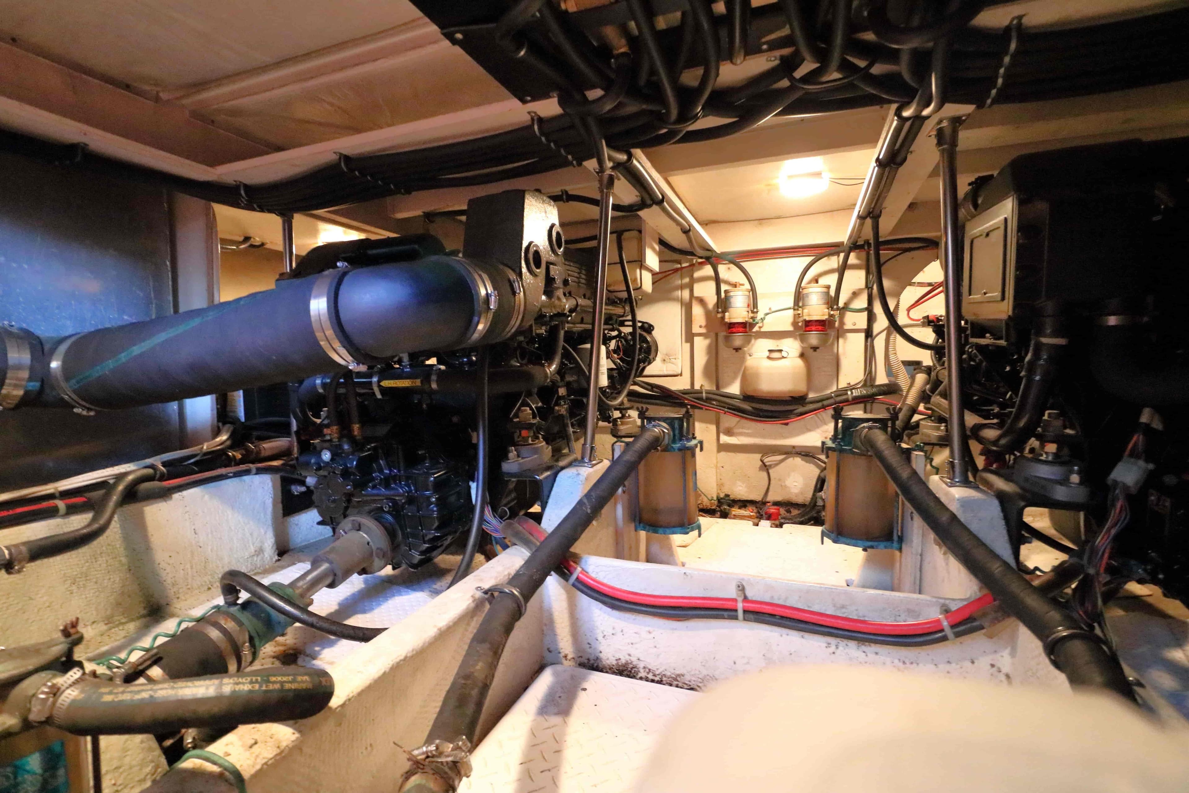 Engine room of a 1995 Bayliner 3988 Command Bridge Motoryacht, showcasing mechanical components.