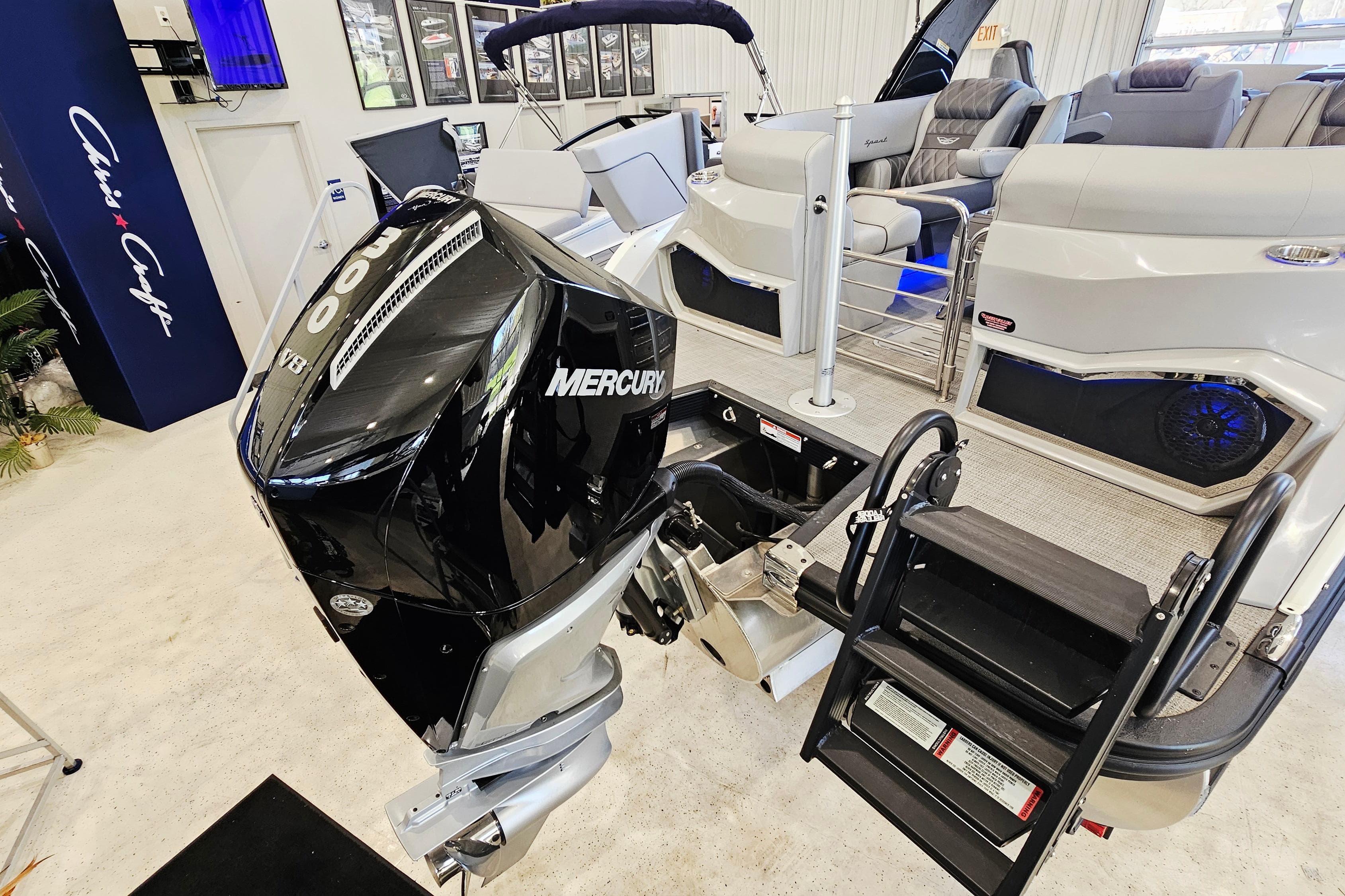 2024 Bennington RX 23 RXFBA boat with Mercury V8 engine, showcased indoors.