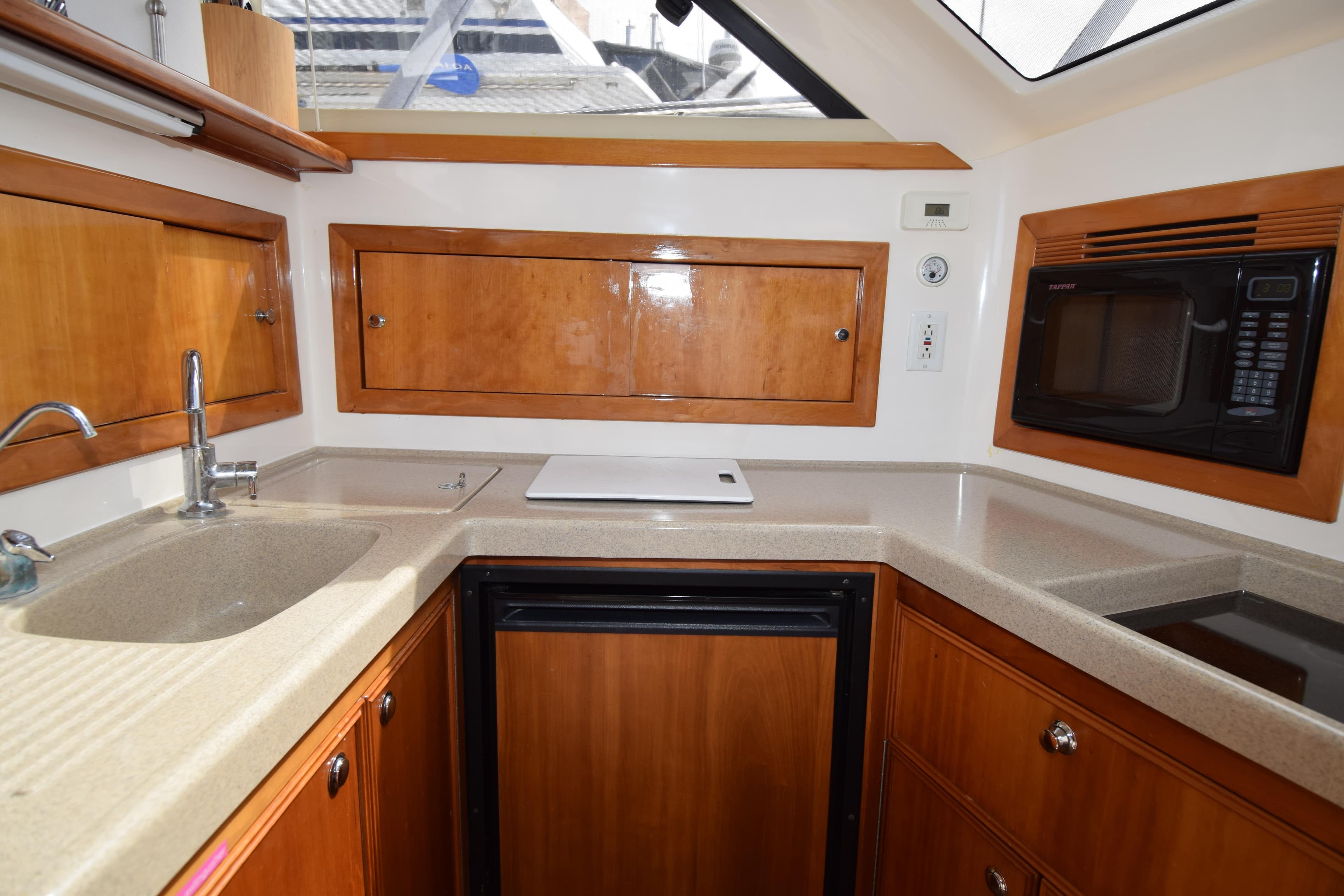 2005 Riviera 33 Open Flybridge yacht kitchen with wood cabinets and modern appliances.