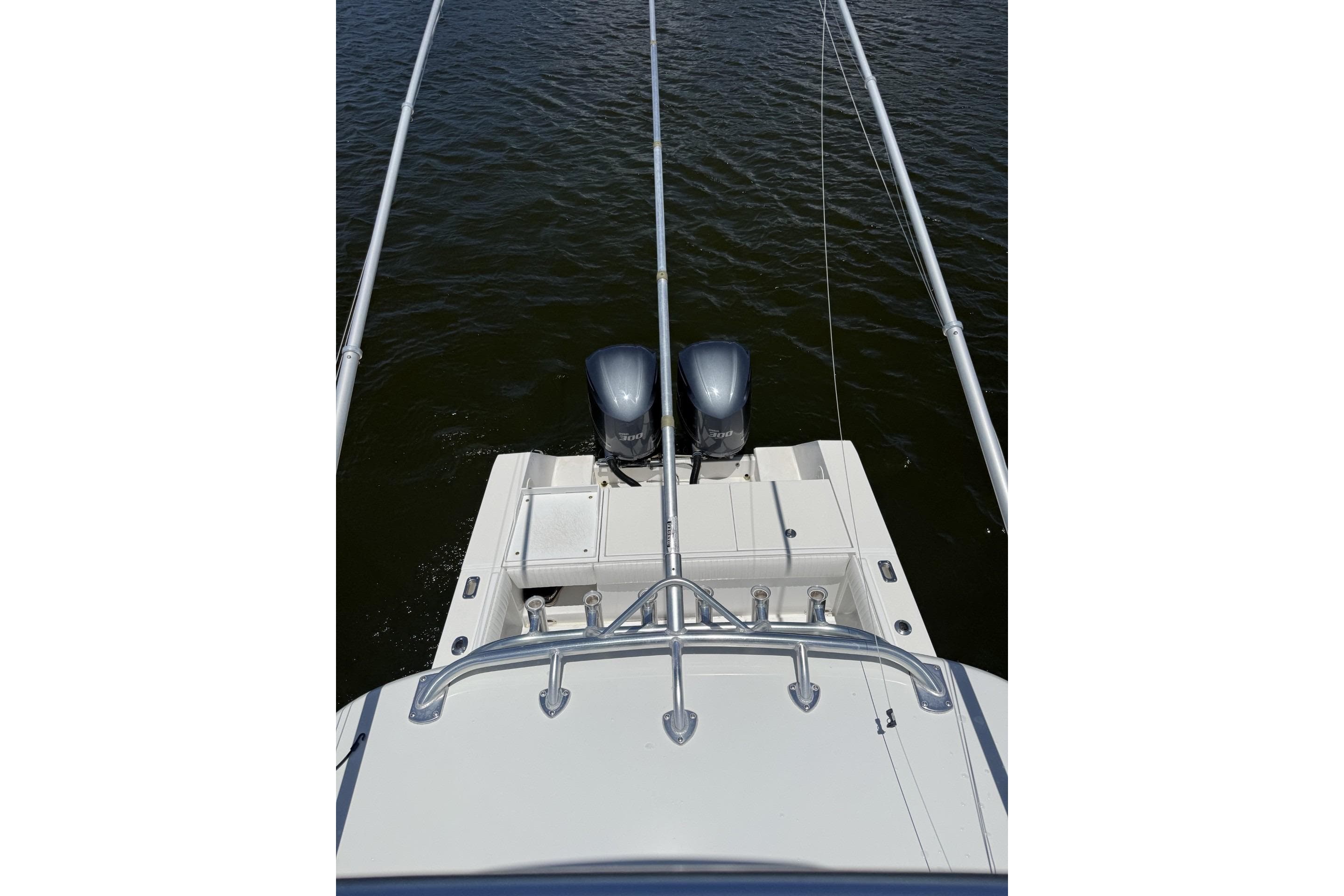 2006 Regulator 32 Center Console boat with dual engines on calm water.