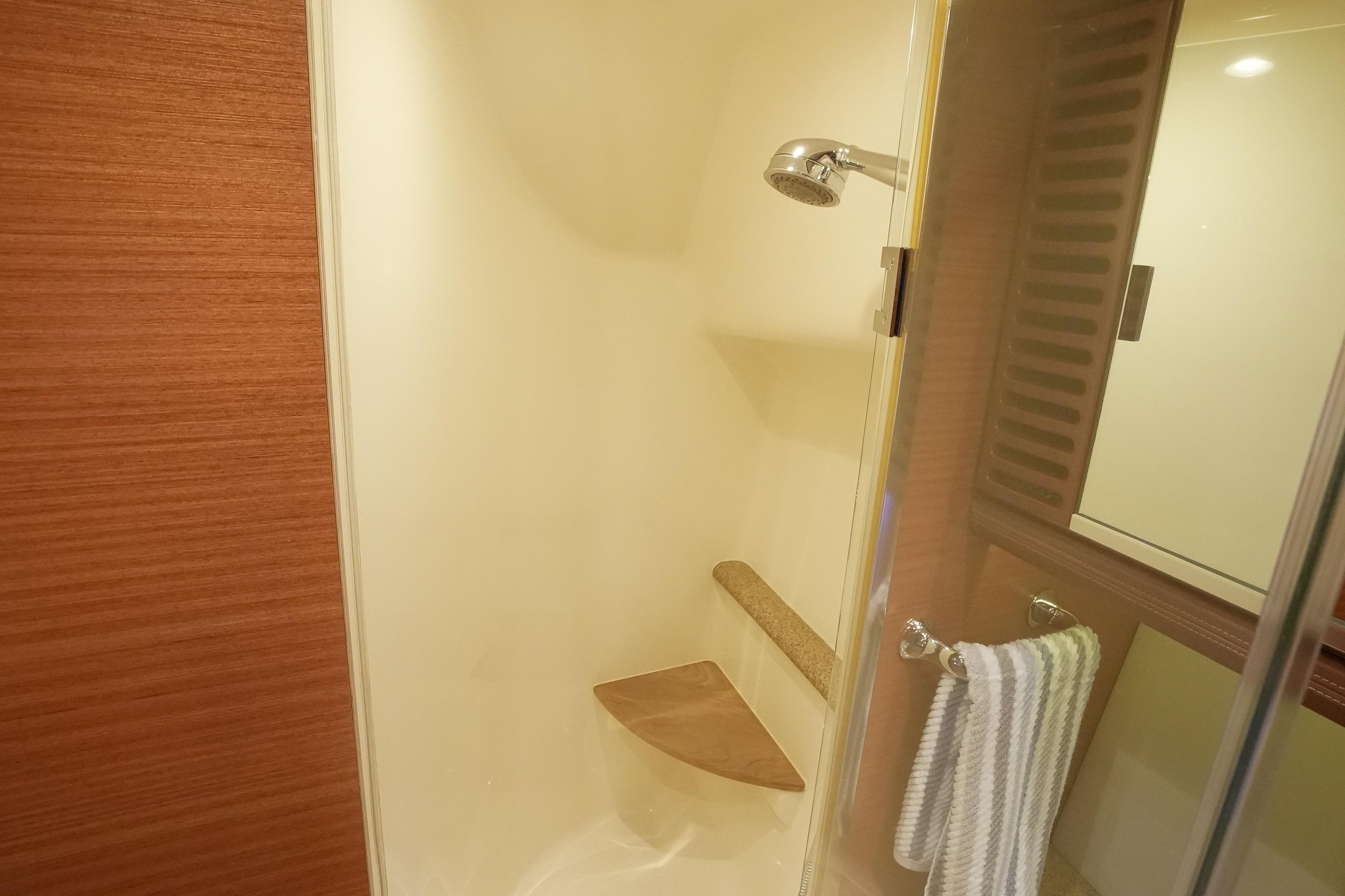 Shower area in 2013 Zeelander Z44 yacht, featuring wooden accents and modern fixtures.