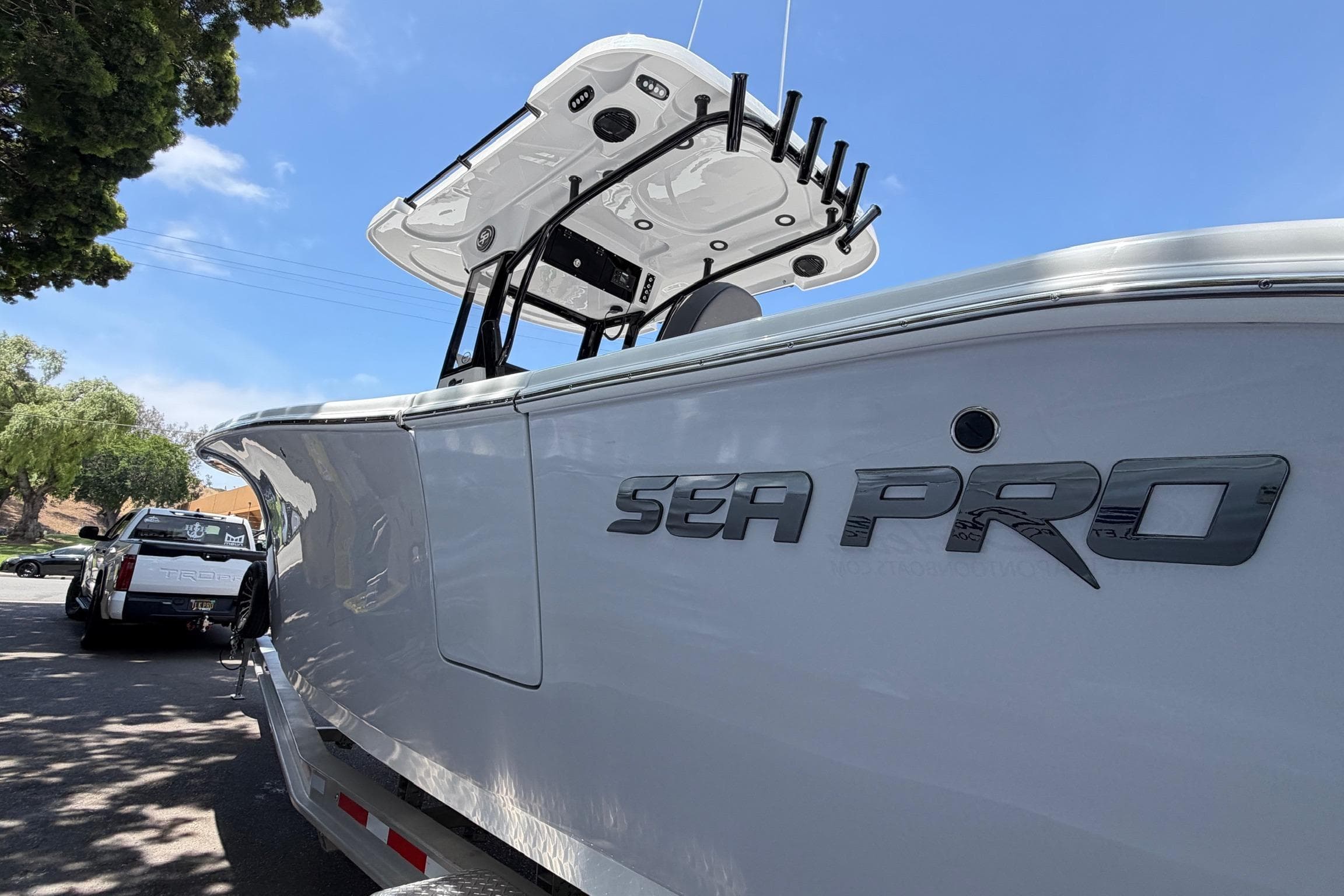 2026 Sea Pro 262 Offshore boat with sleek design, parked on a trailer under a clear sky.