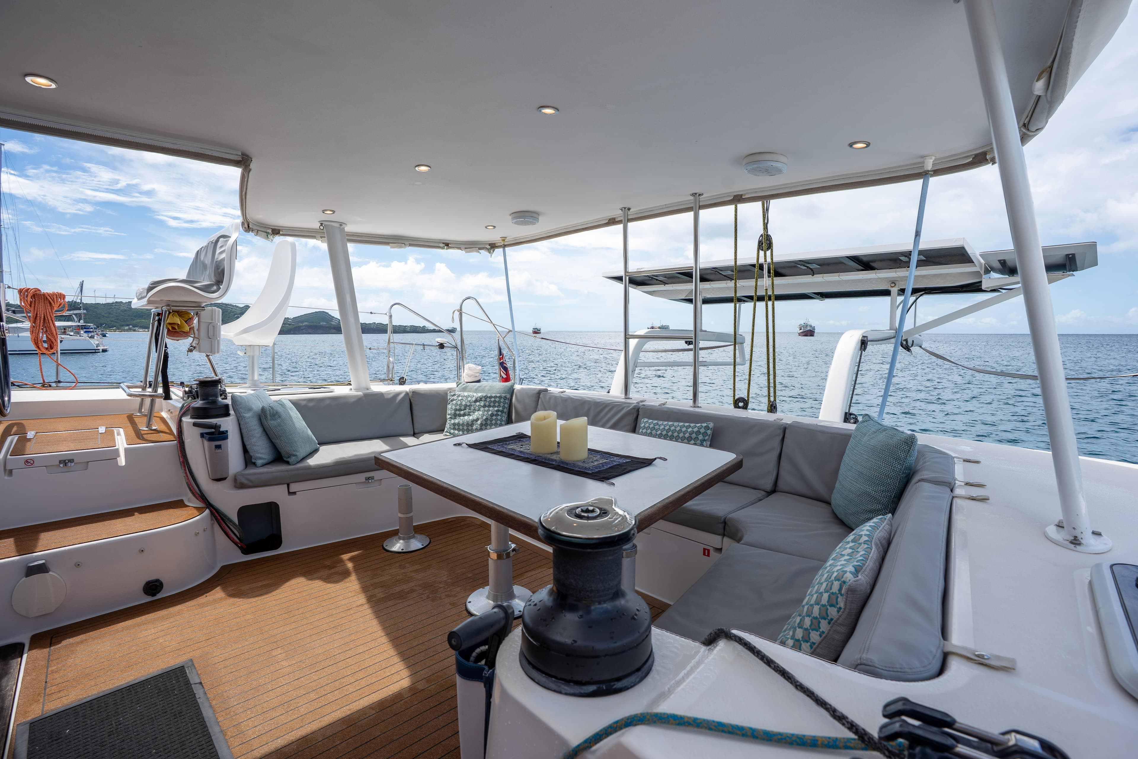Luxurious 2020 Outremer 51 catamaran deck with seating, ocean view, and modern amenities.