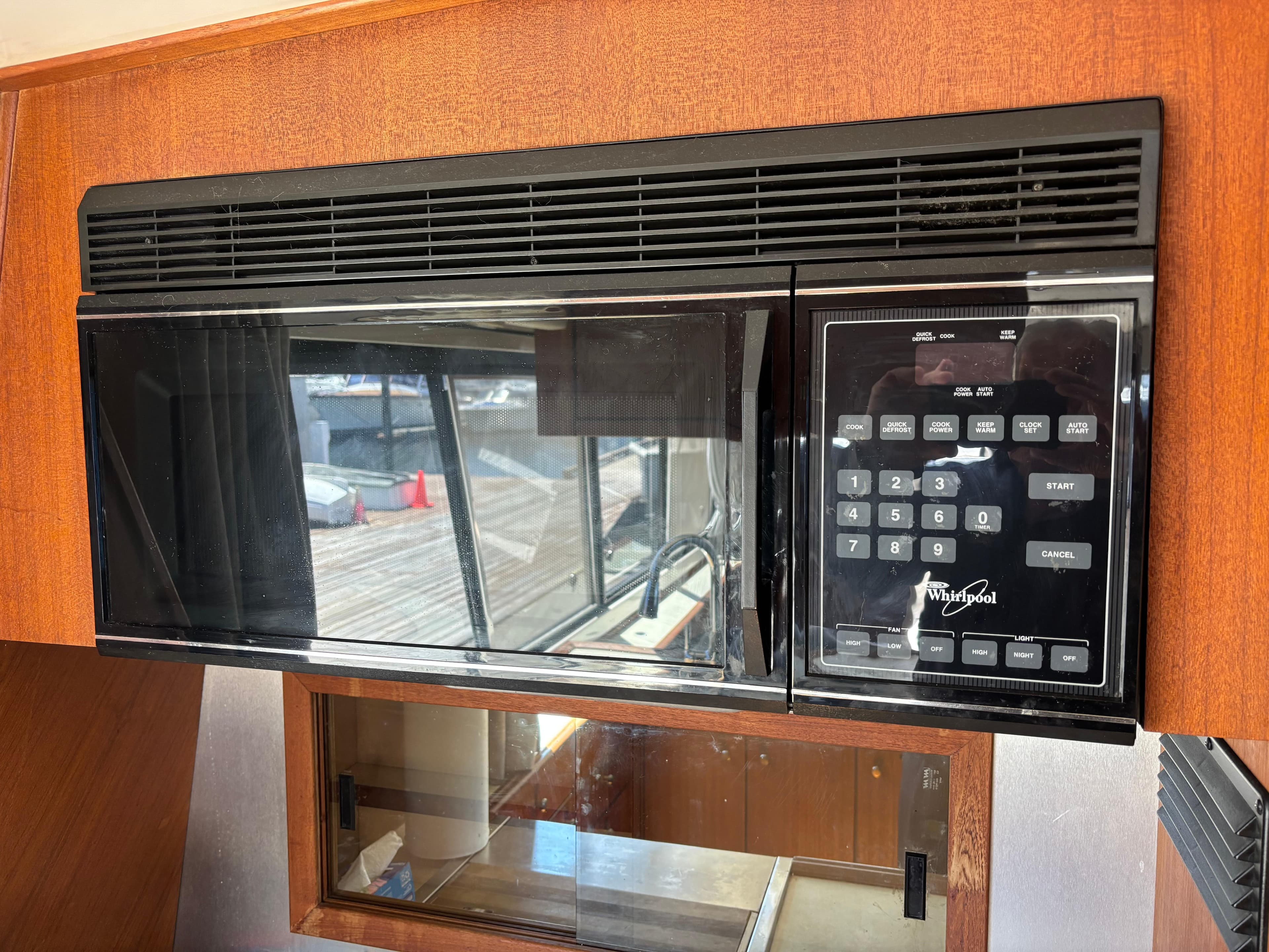 Built-in microwave in a 1994 Bayliner 4700 yacht kitchen.
