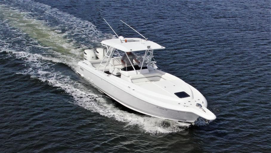 2003 Intrepid 32 boat cruising on open water, aerial view.