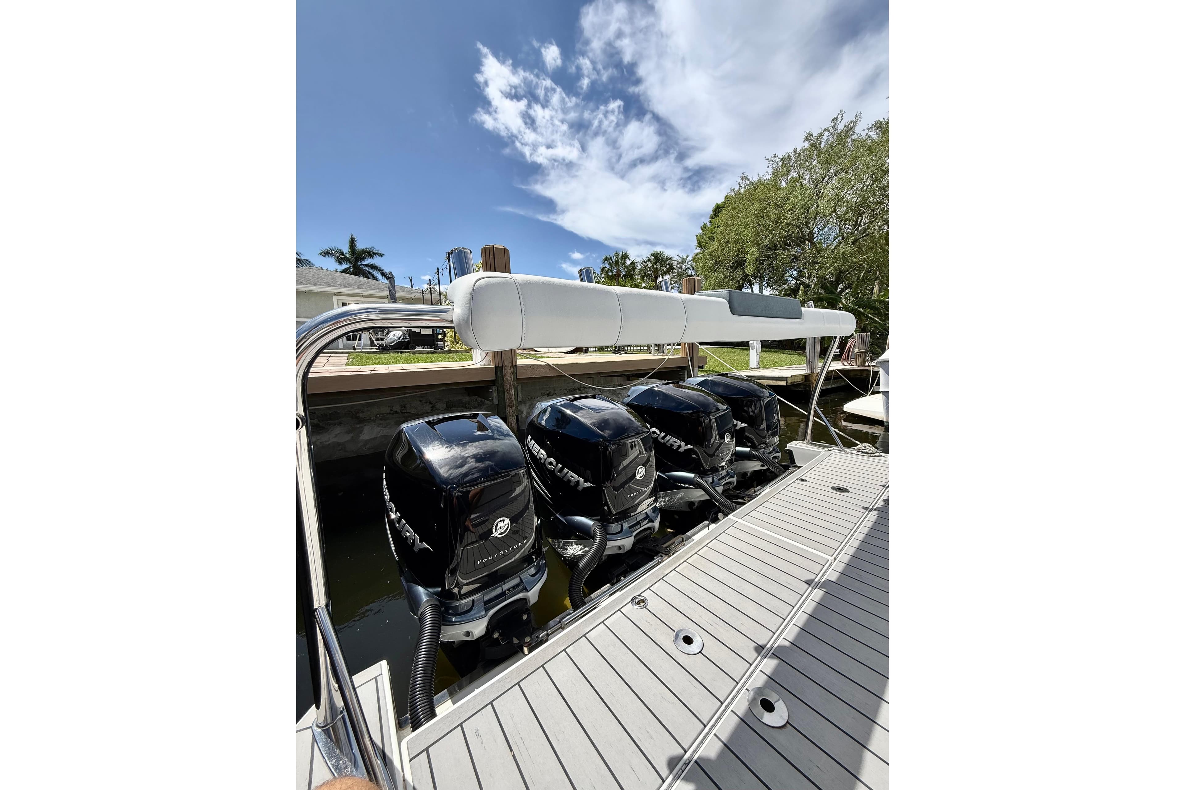 2020 Formula 400 Super Sport Crossover with four Mercury outboard engines docked under a clear sky.