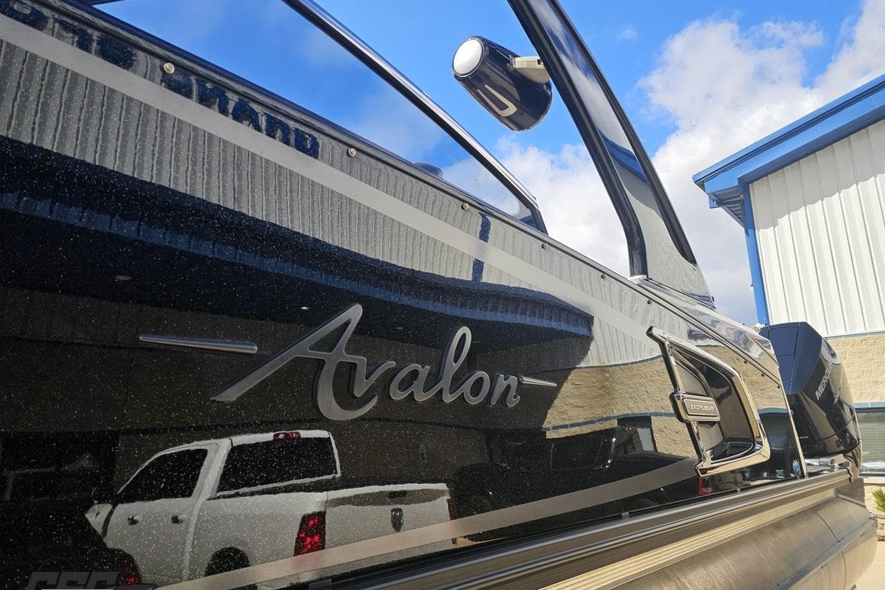 2024 Avalon Excalibur Quad Lounge Windshield boat with sleek design and reflective surface.