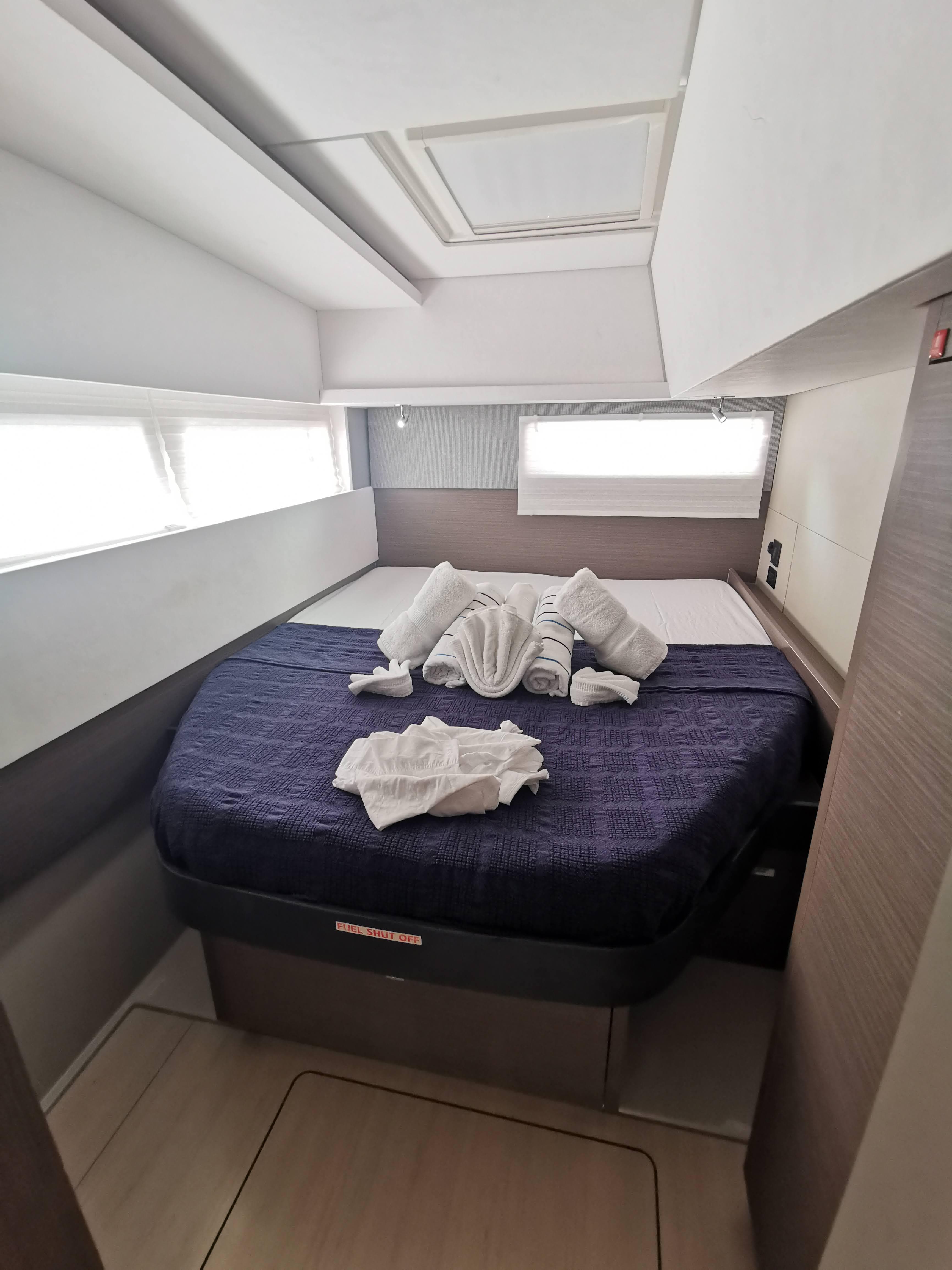 Cozy bedroom in 2022 Leopard 45 yacht with elegant towel decor.