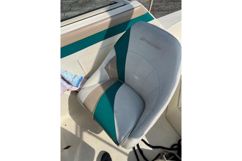 1996 Rinker Fiesta Vee 265 boat seat with teal and beige upholstery.