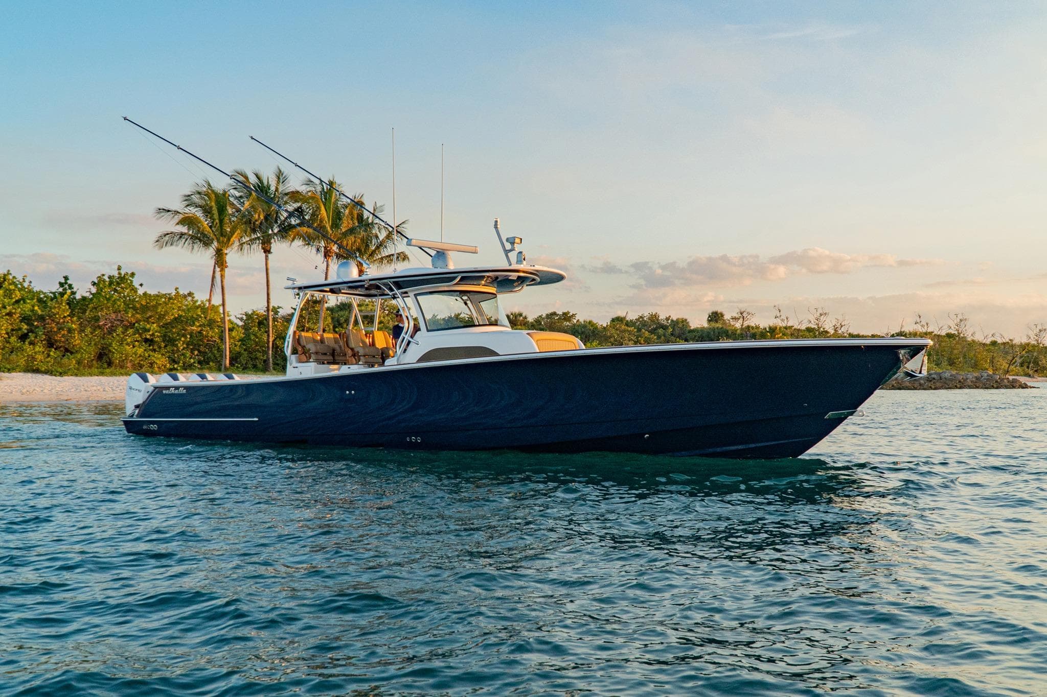 2026 Valhalla Boatworks V-46 cruising near tropical shoreline at sunset.
