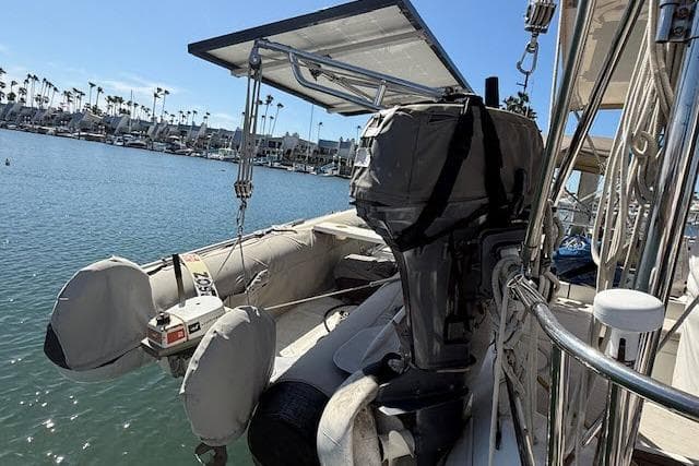 Beneteau 393 sailboat with outboard motor and dinghy, docked in a marina, 2005 model.
