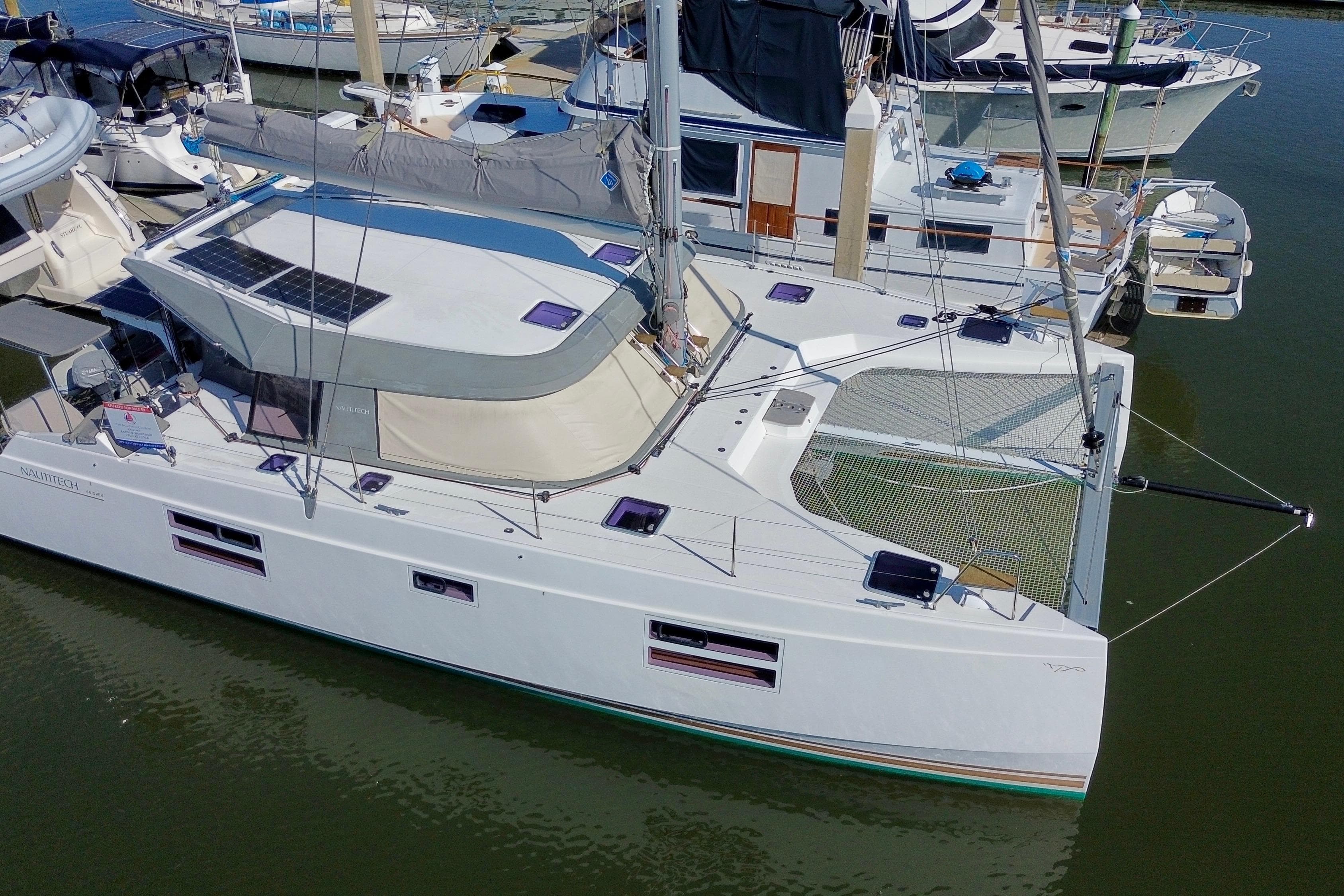 2019 Nautitech 40 Open catamaran docked, featuring solar panels and spacious deck.