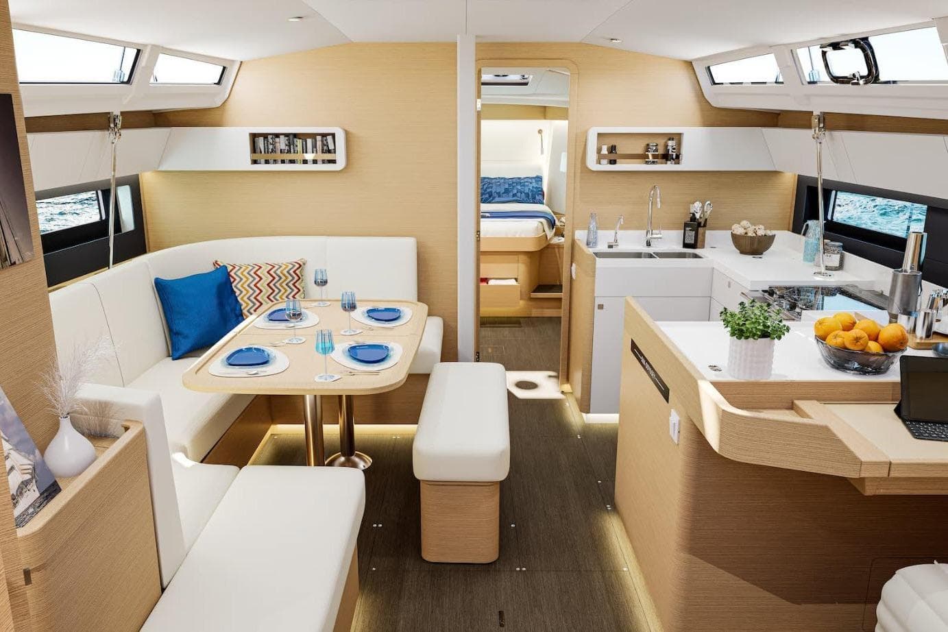 Luxurious interior of 2026 Jeanneau Sun Odyssey 455 yacht with modern dining and kitchen area.