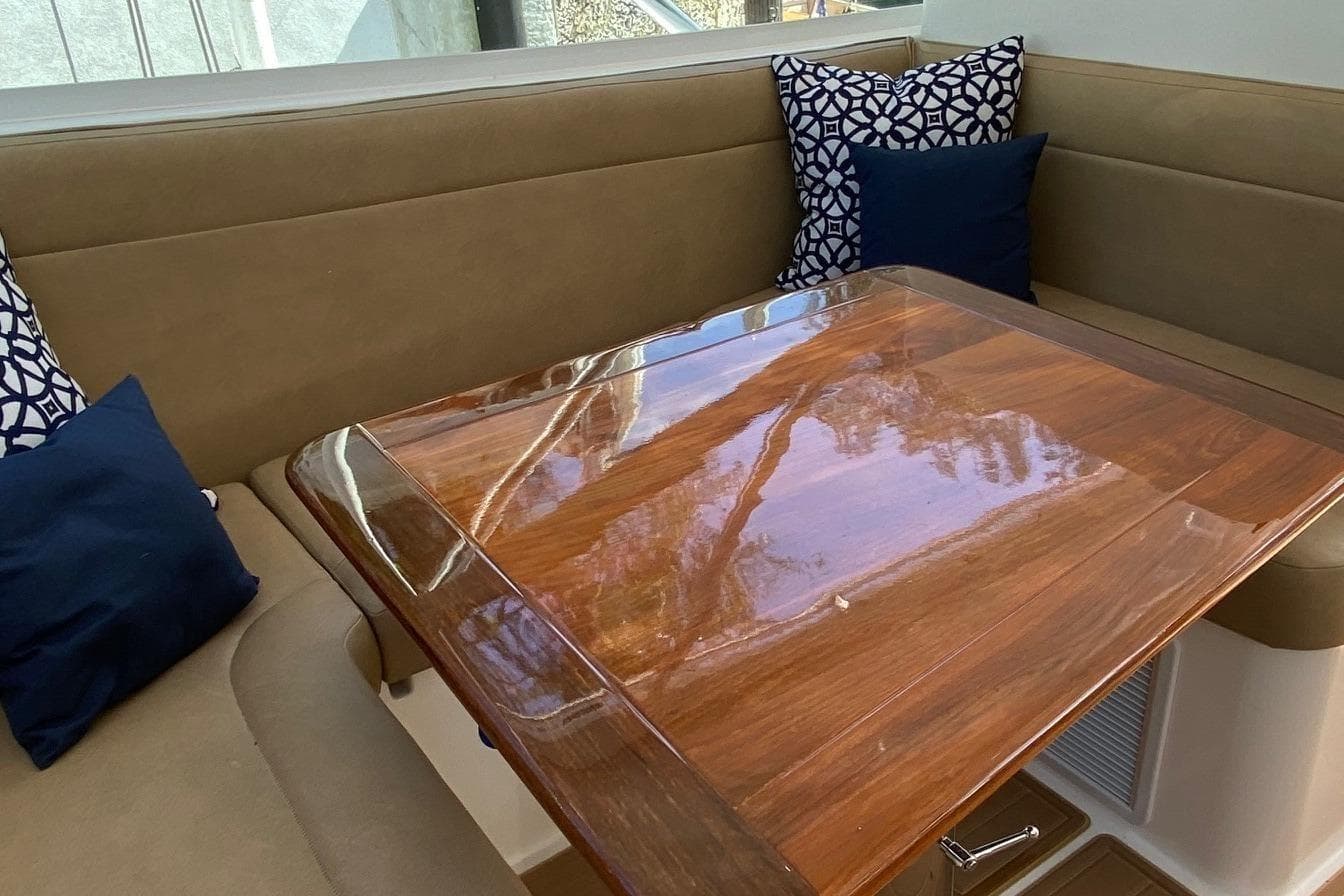 Luxurious interior of 2008 Contender 38 Express with polished wood table and cushioned seating.