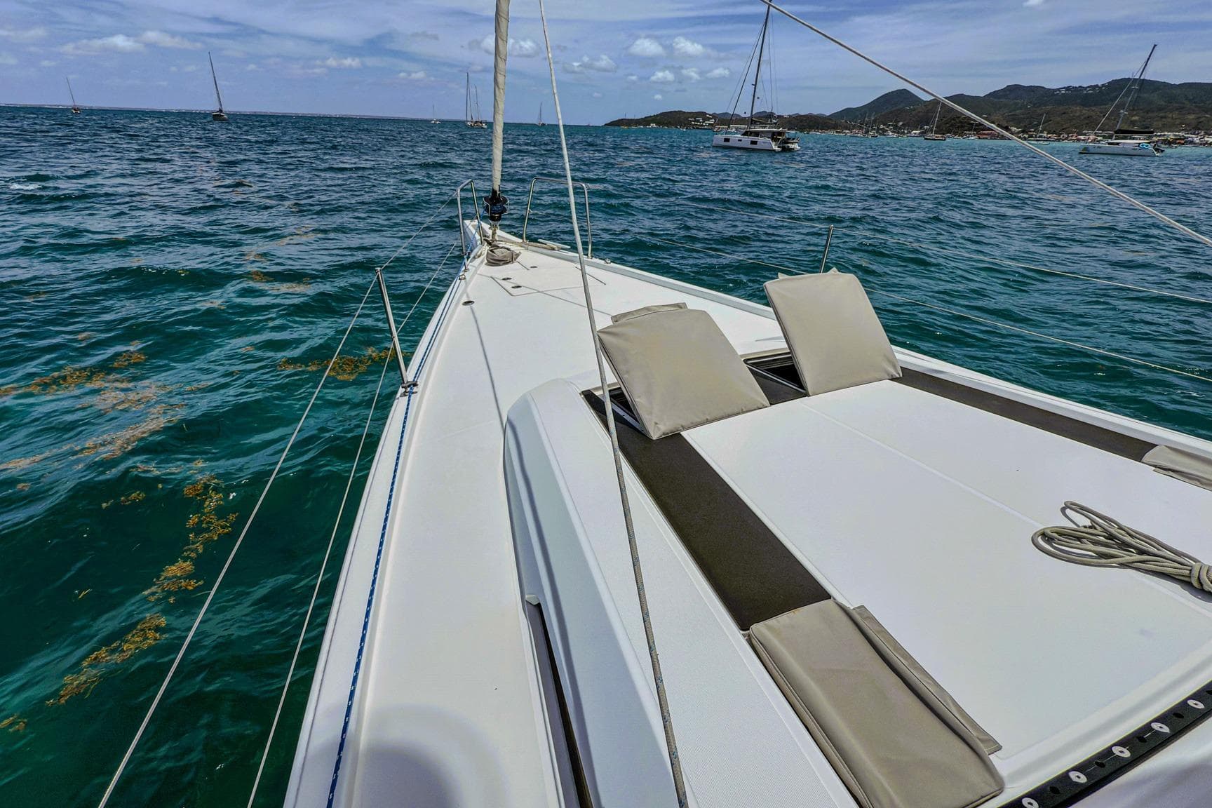 2020 Beneteau Oceanis 46.1 sailboat on calm sea with scenic coastline.