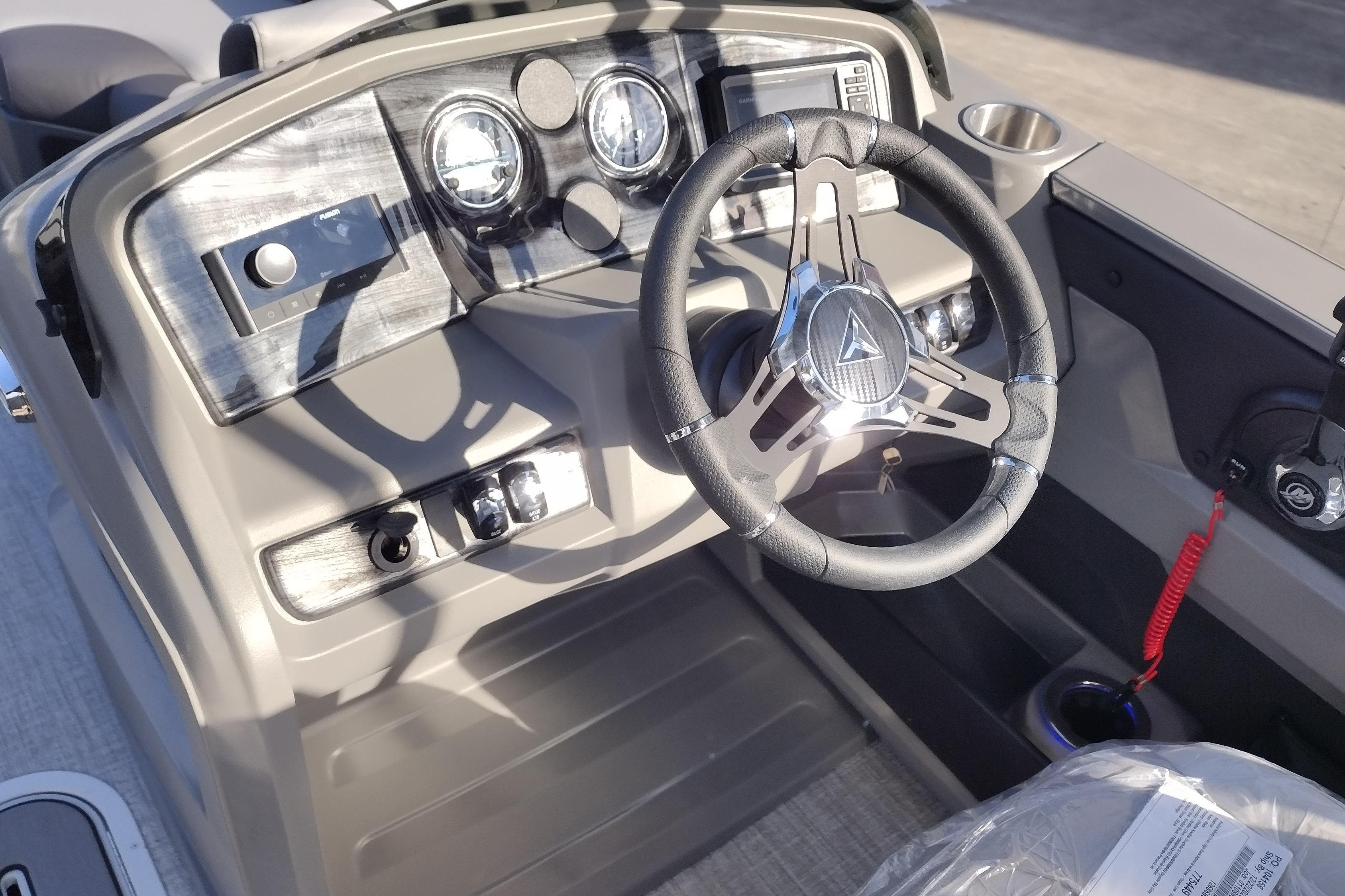 2026 Tahoe Pontoon 23 LTZ Quad Lounge dashboard with steering wheel and controls.