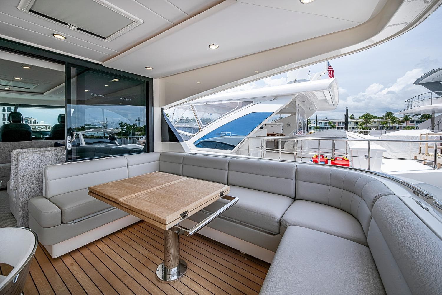 Luxurious 2025 Maritimo M75 yacht interior with elegant seating and wooden table.