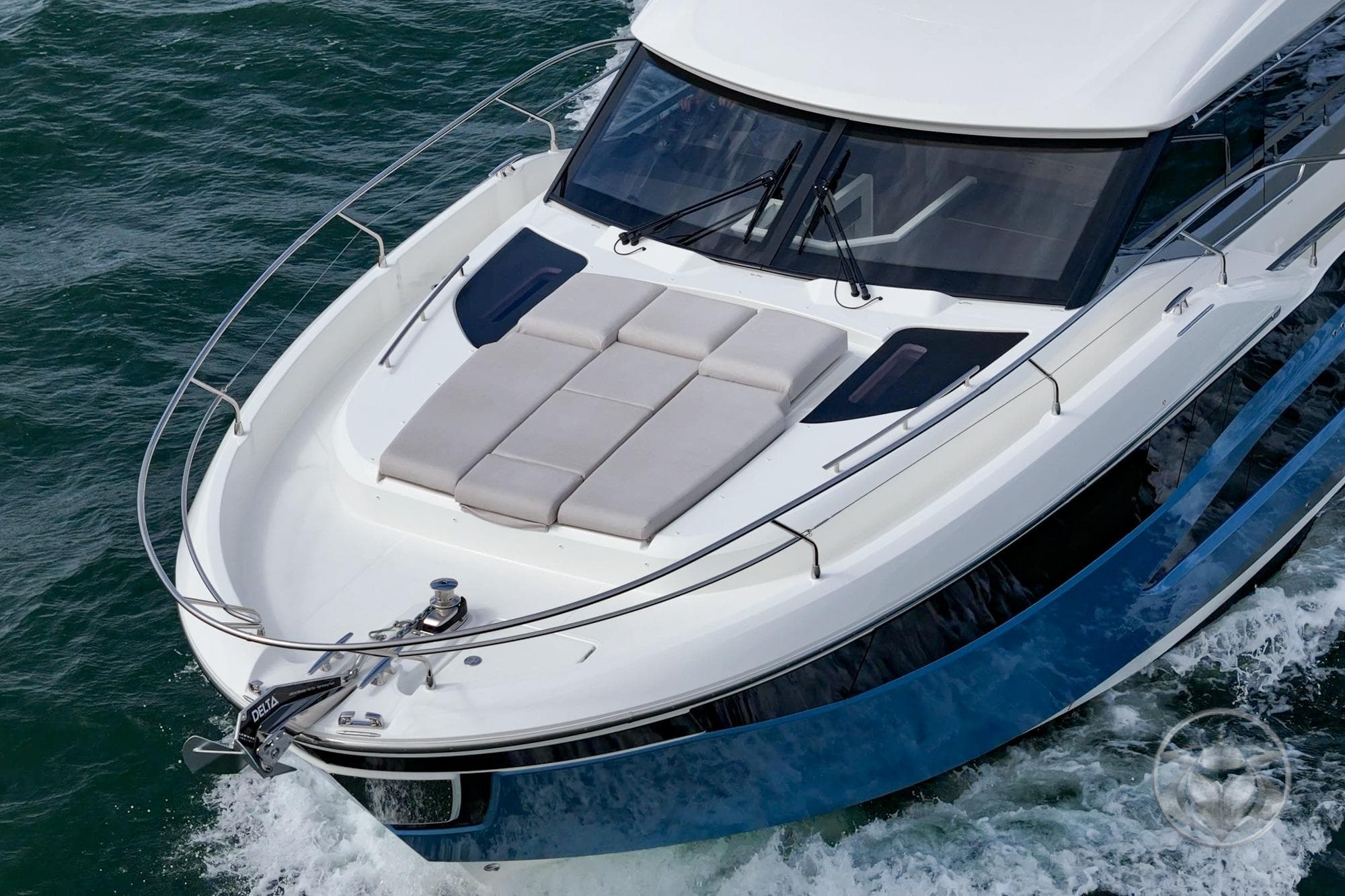 Prestige F4.9 yacht cruising on water, 2026 model, featuring sleek design and sunbathing area.
