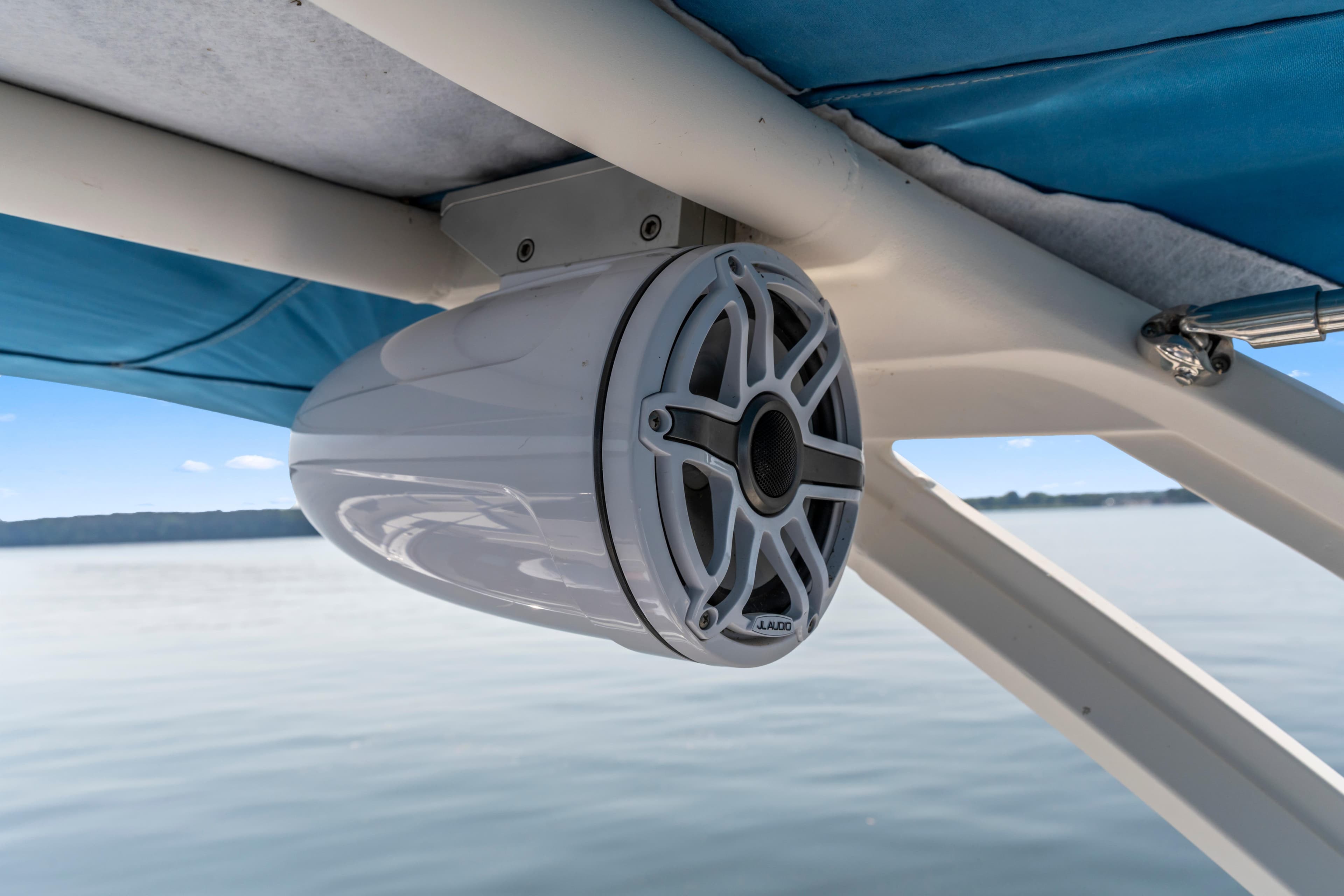 Speaker mounted on a 2022 Chaparral 247 SSX boat, under blue canopy.