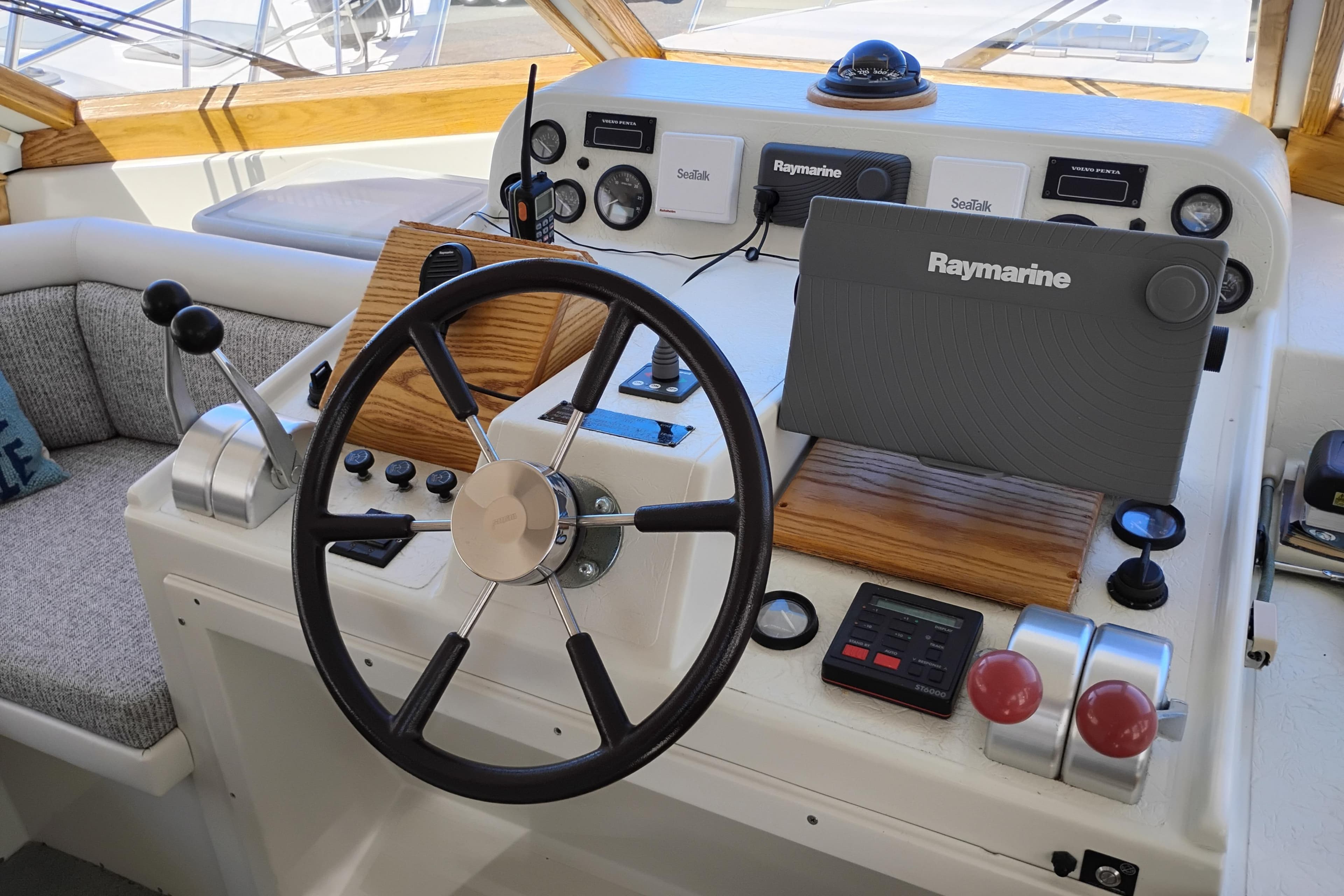 Navigator Classic 1994 boat helm with Raymarine navigation system and steering wheel.