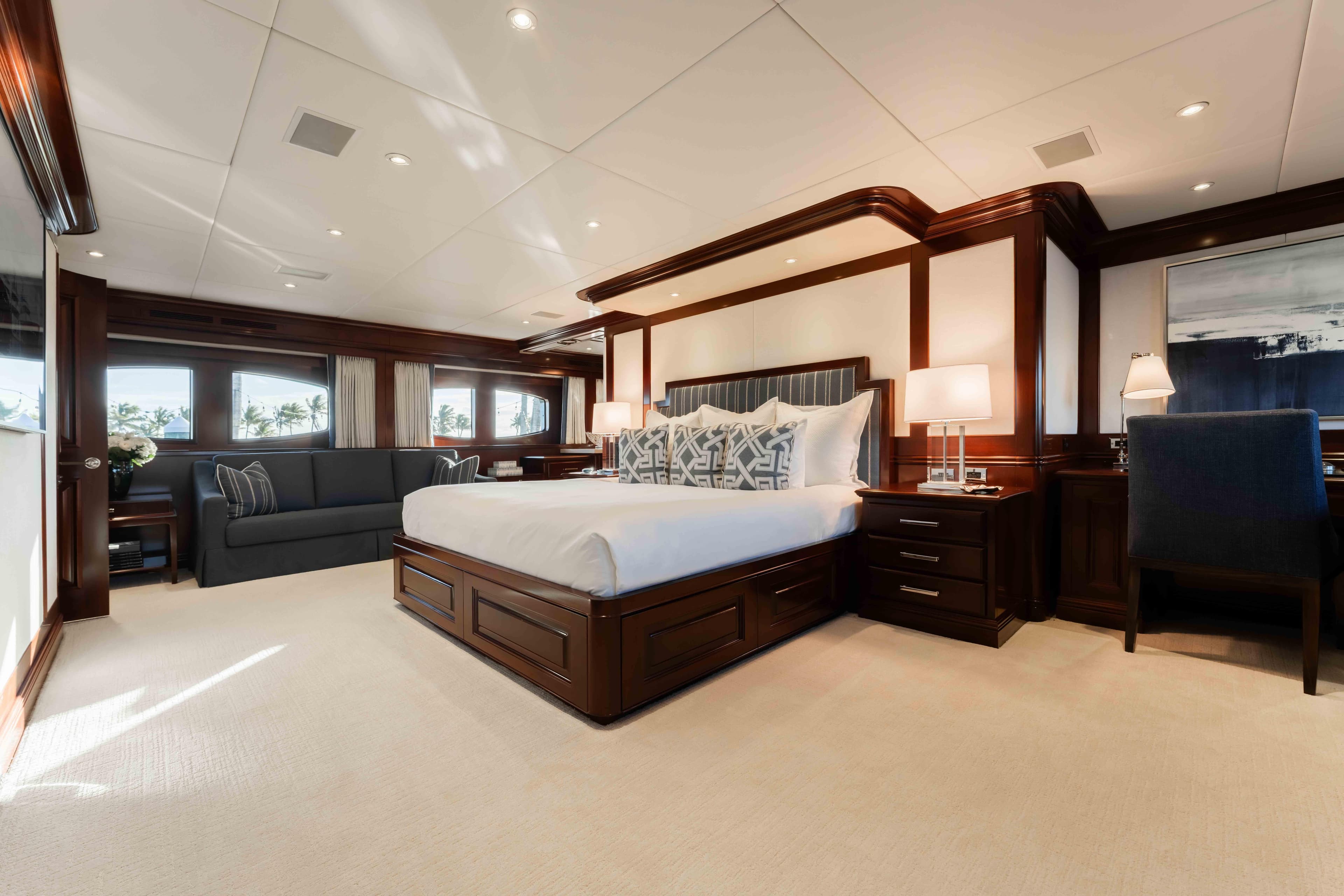 Luxurious bedroom interior on 2004 Trinity Yachts motor yacht, featuring elegant wood finishes.