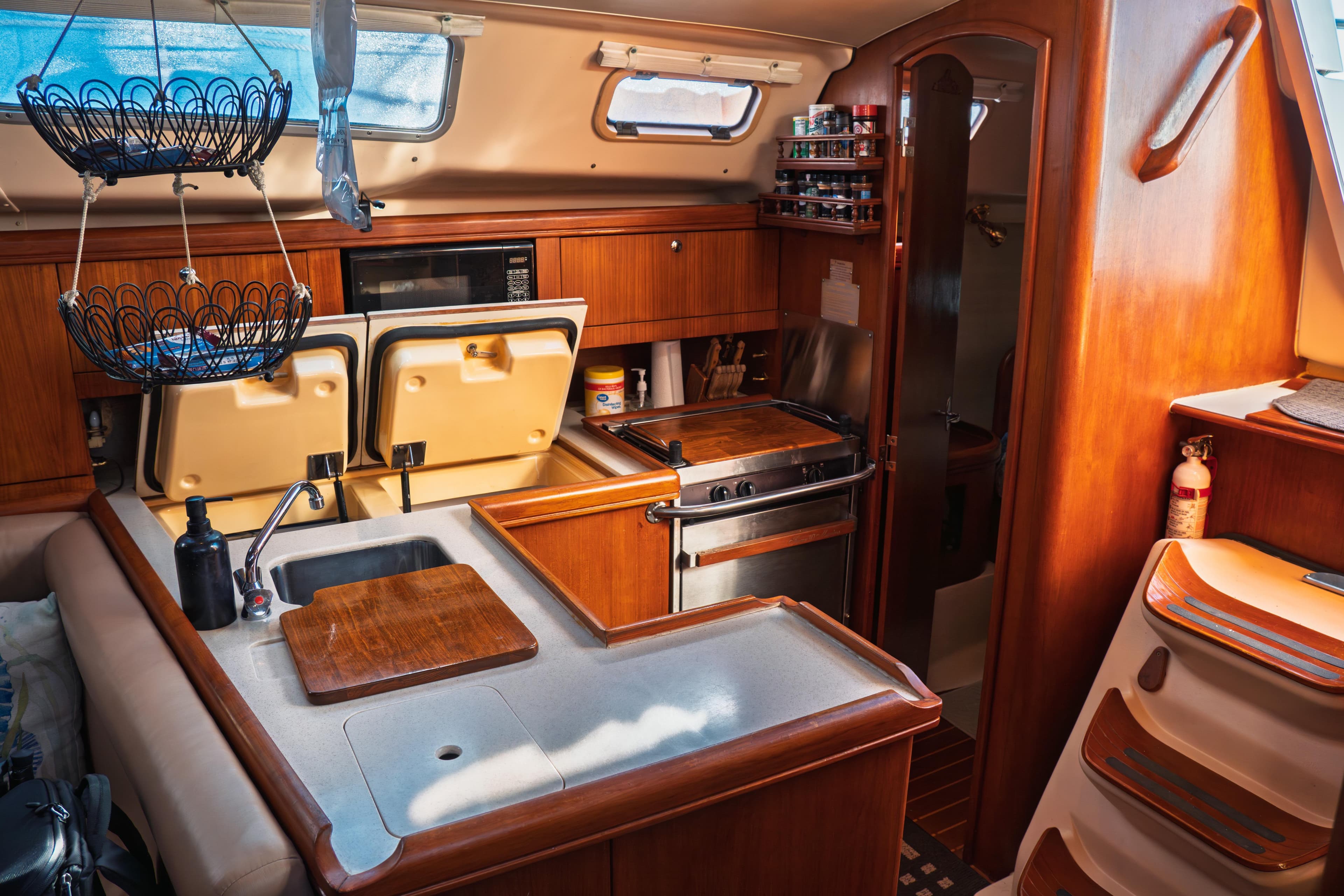 2003 Hunter 356 yacht interior kitchen with wood cabinetry and modern appliances.