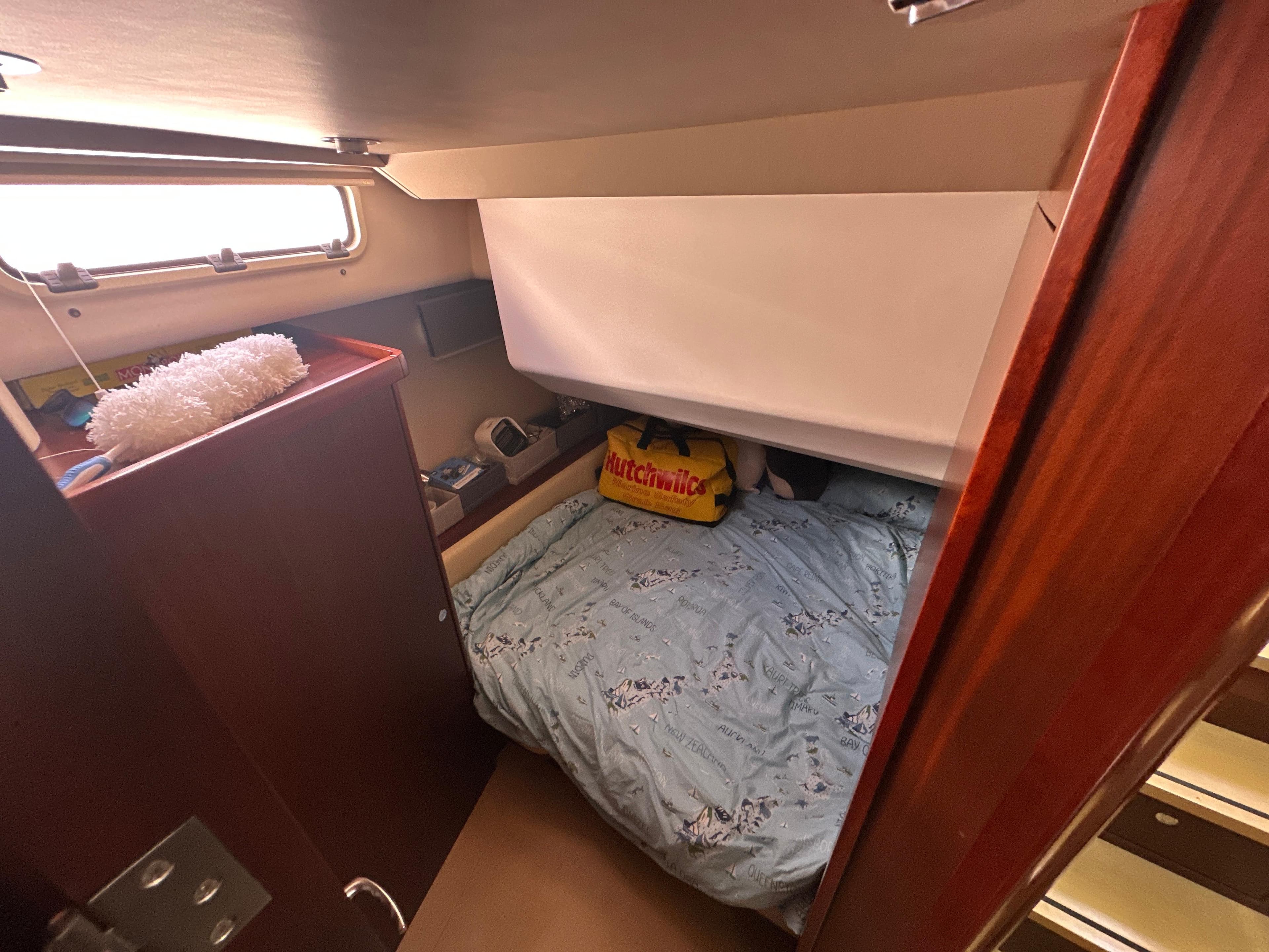 Cozy cabin interior of 2011 Moody DS 45 yacht with bed and window.