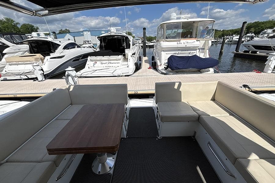 2016 Cruisers Yachts 390 Express Coupe interior with docked boats in marina background.