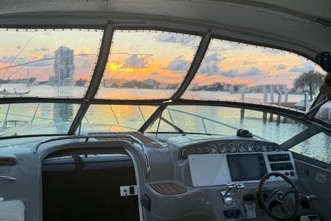 2001 Wellcraft Martinique 3700 boat interior with sunset view through windshield.