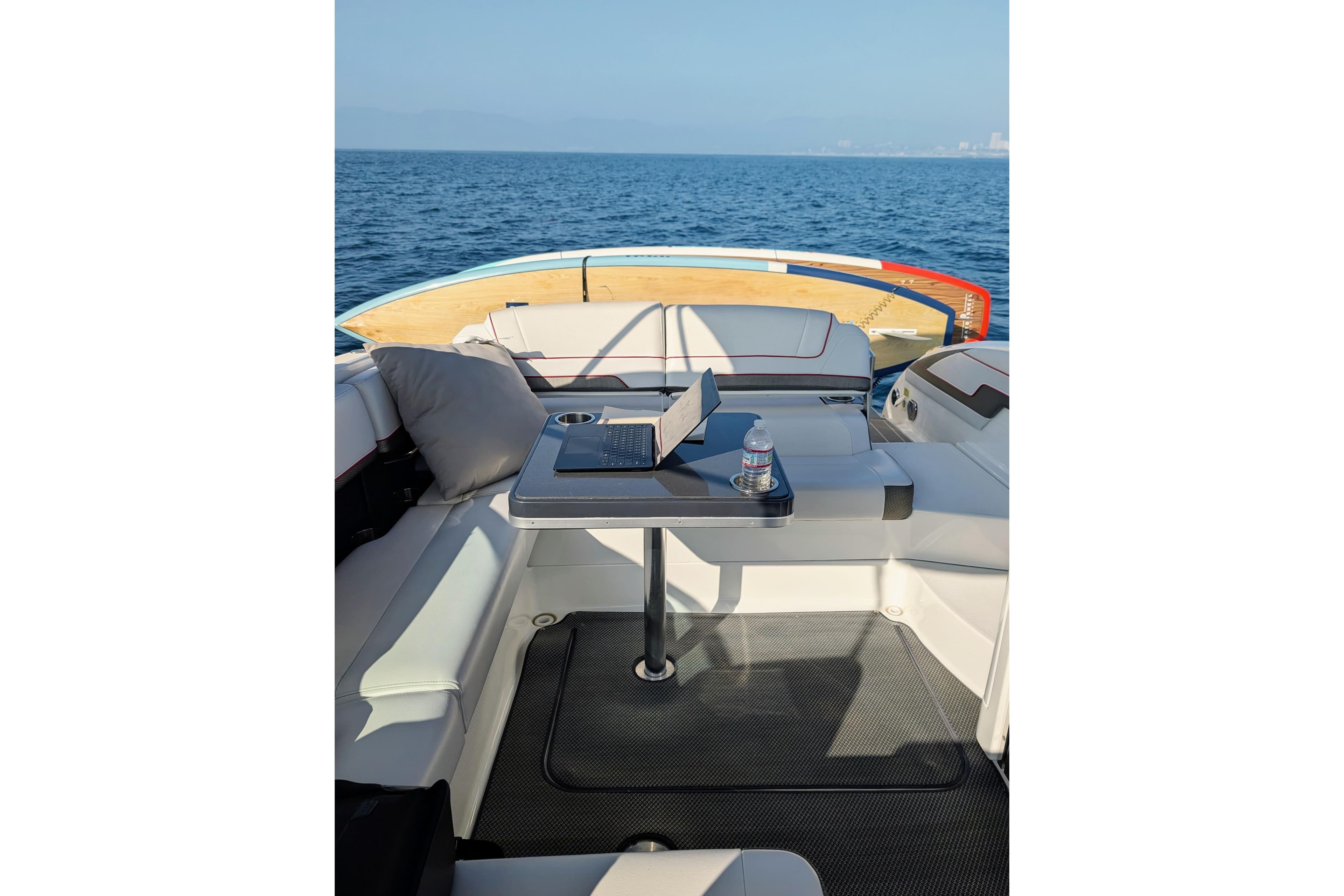 2019 Formula 310 Bowrider interior with seating and table on open water.