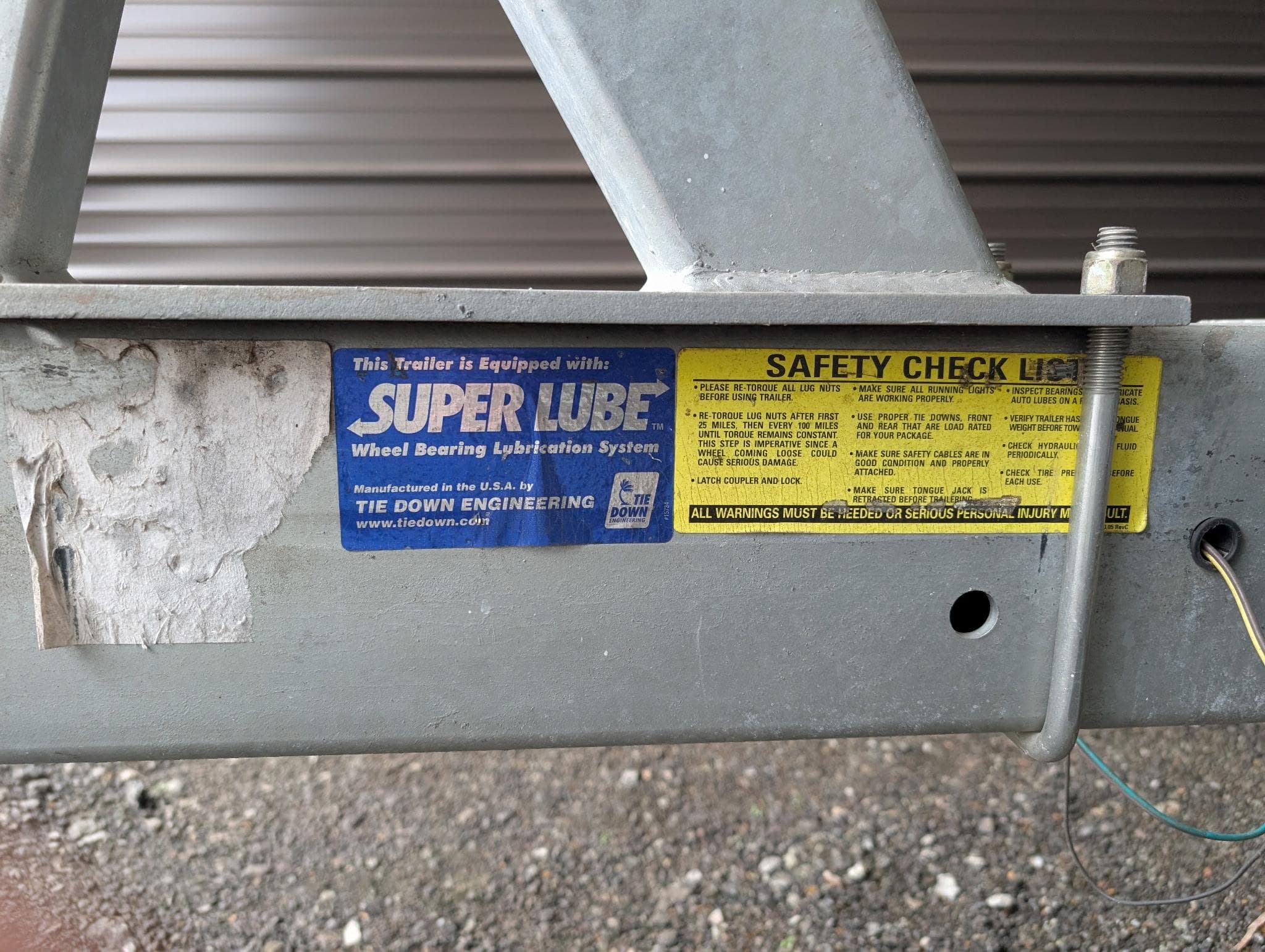 Trailer frame with Super Lube and safety check labels, Marinette 28 Sport Fish Fly Bridge, 1989.