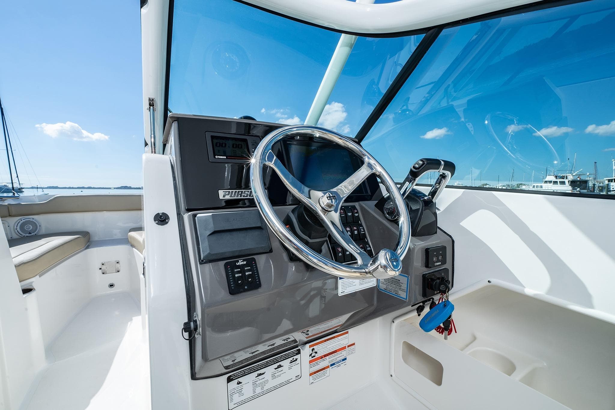 2026 Pursuit DC 266 Dual Console boat helm with steering wheel and controls.