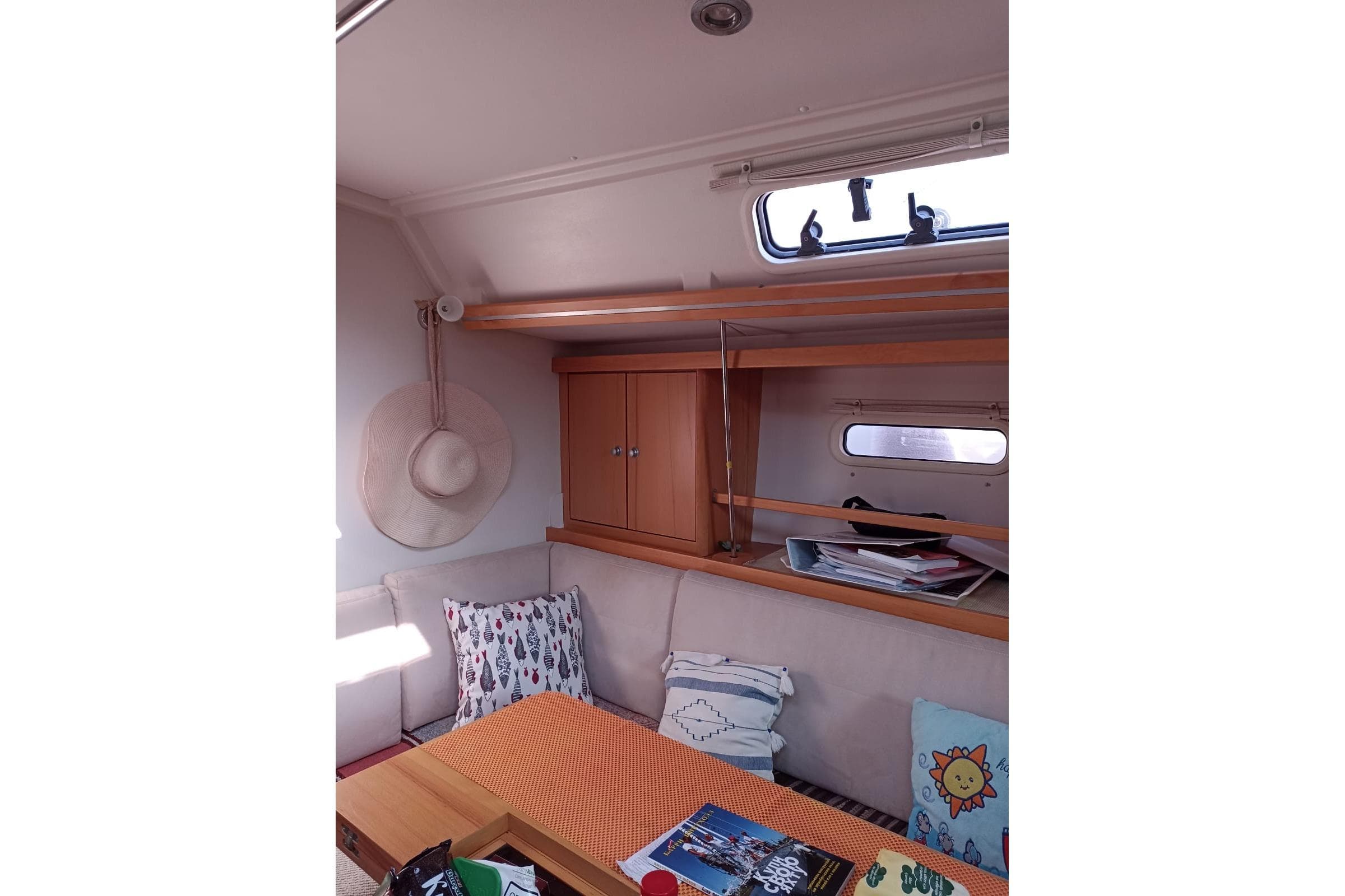 Interior of 2011 Hanse 400 yacht with cozy seating and decorative pillows.