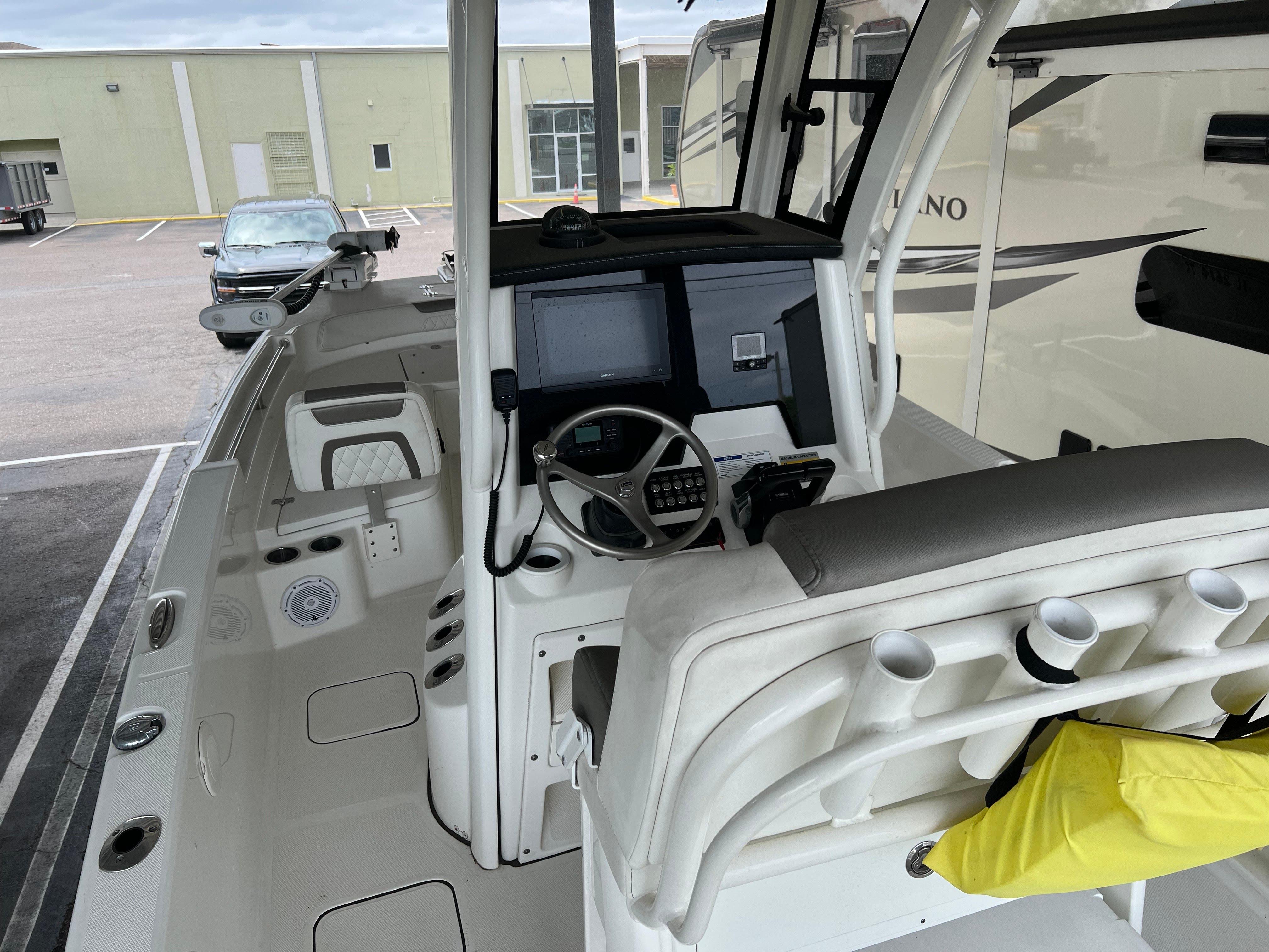 2022 World Cat 235 CC boat interior with helm, steering wheel, and seating.
