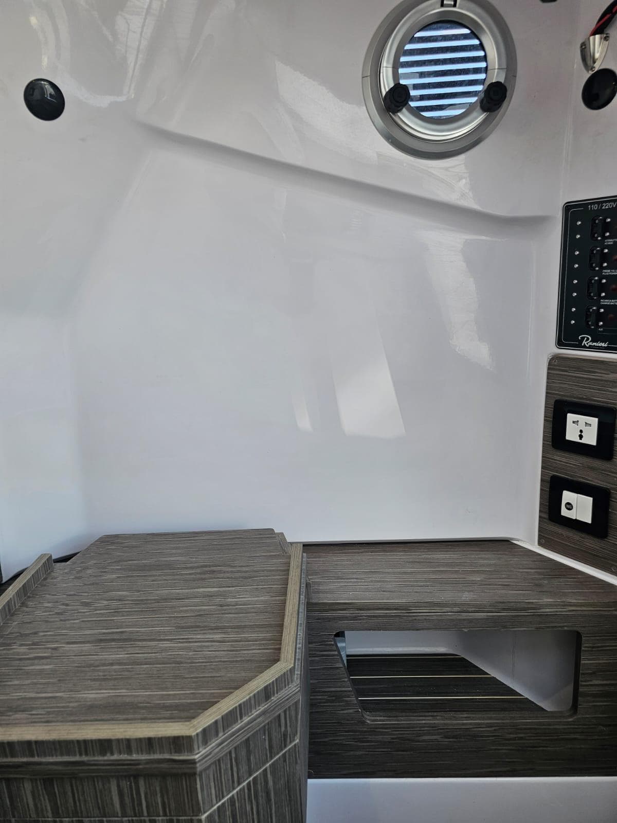 Interior cabin of 2025 Ranieri CAYMAN 27.0 SPORT TOURING boat with modern design.