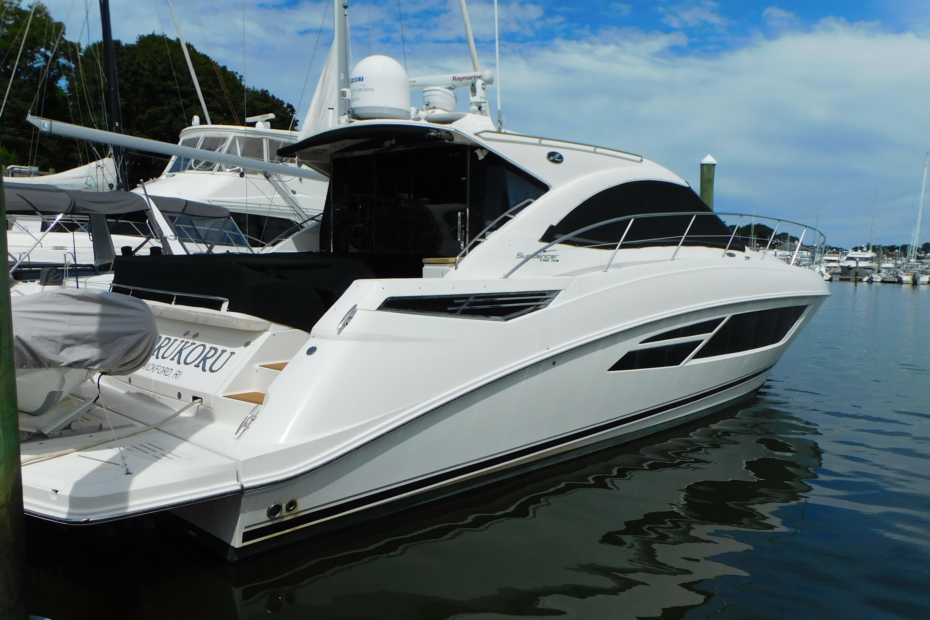 2013 Sea Ray 510 Sundancer yacht docked in a marina under a blue sky.