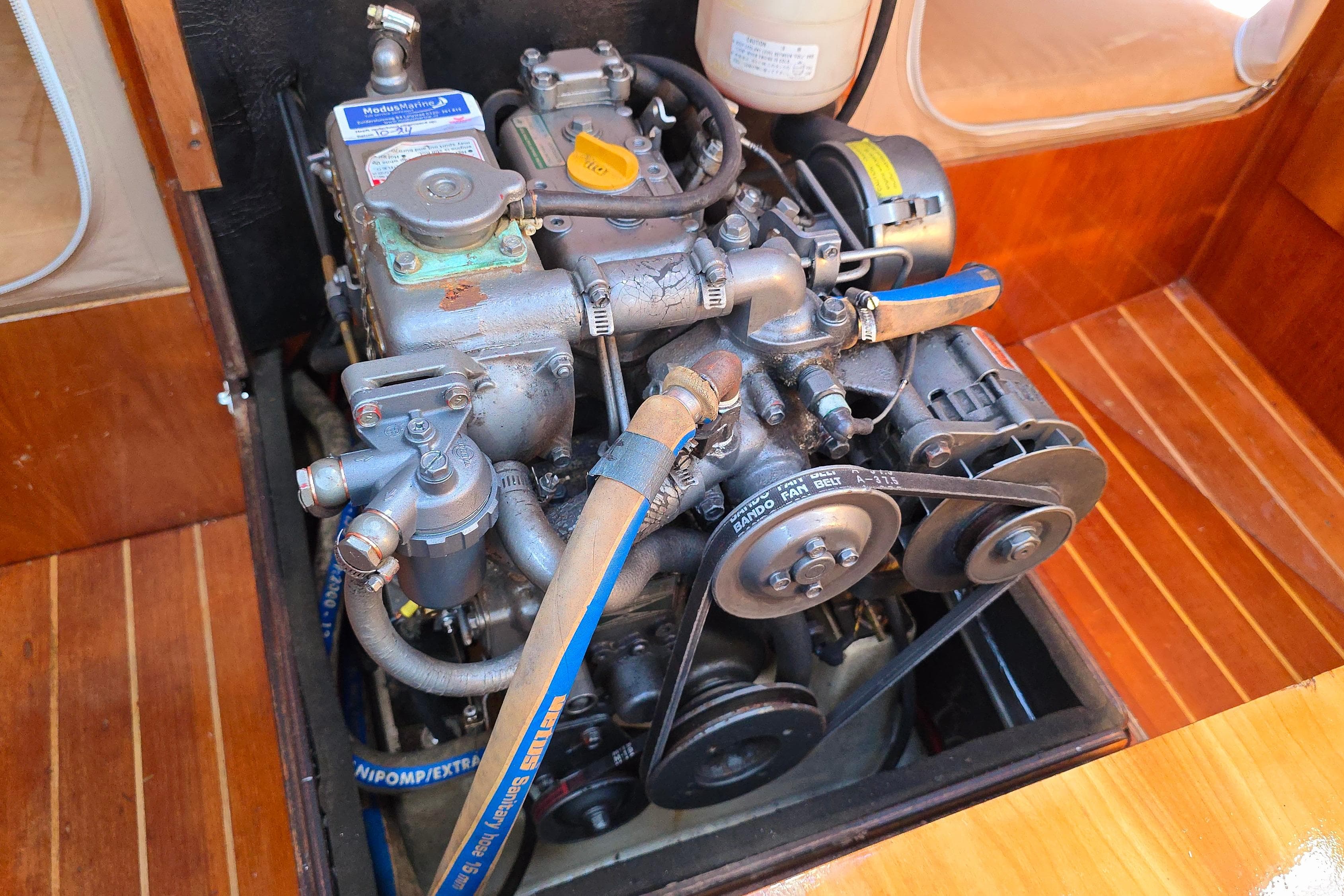 Engine of 2003 FF Boats 1100, showcasing mechanical components and belts.