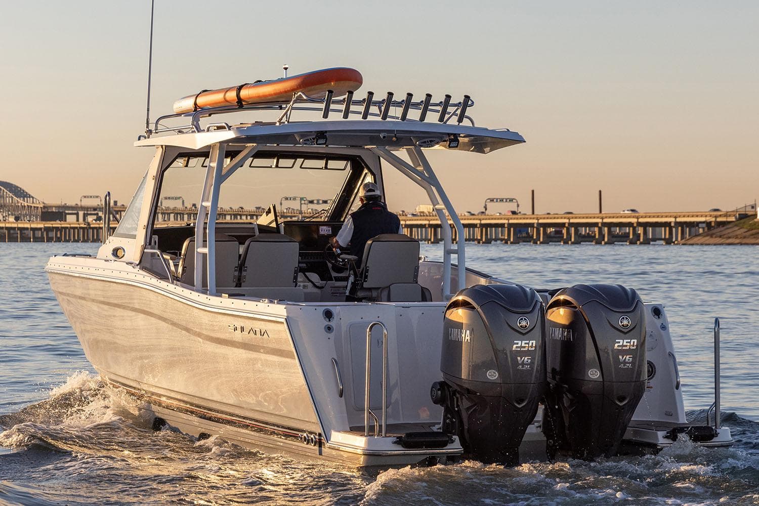 Manufacturer Provided Image: 2025 Solara S-310 CW boat with dual engines cruising on water at sunset.