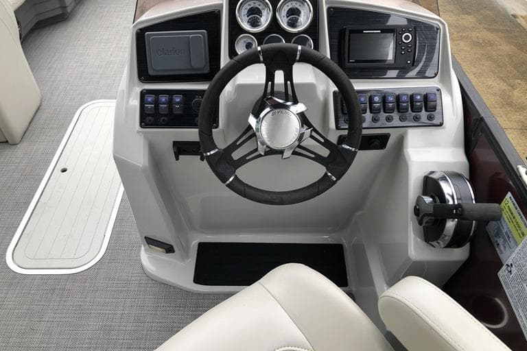 Cockpit of 2022 Sylvan Mirage X X3 CLZ pontoon boat with steering wheel and controls.