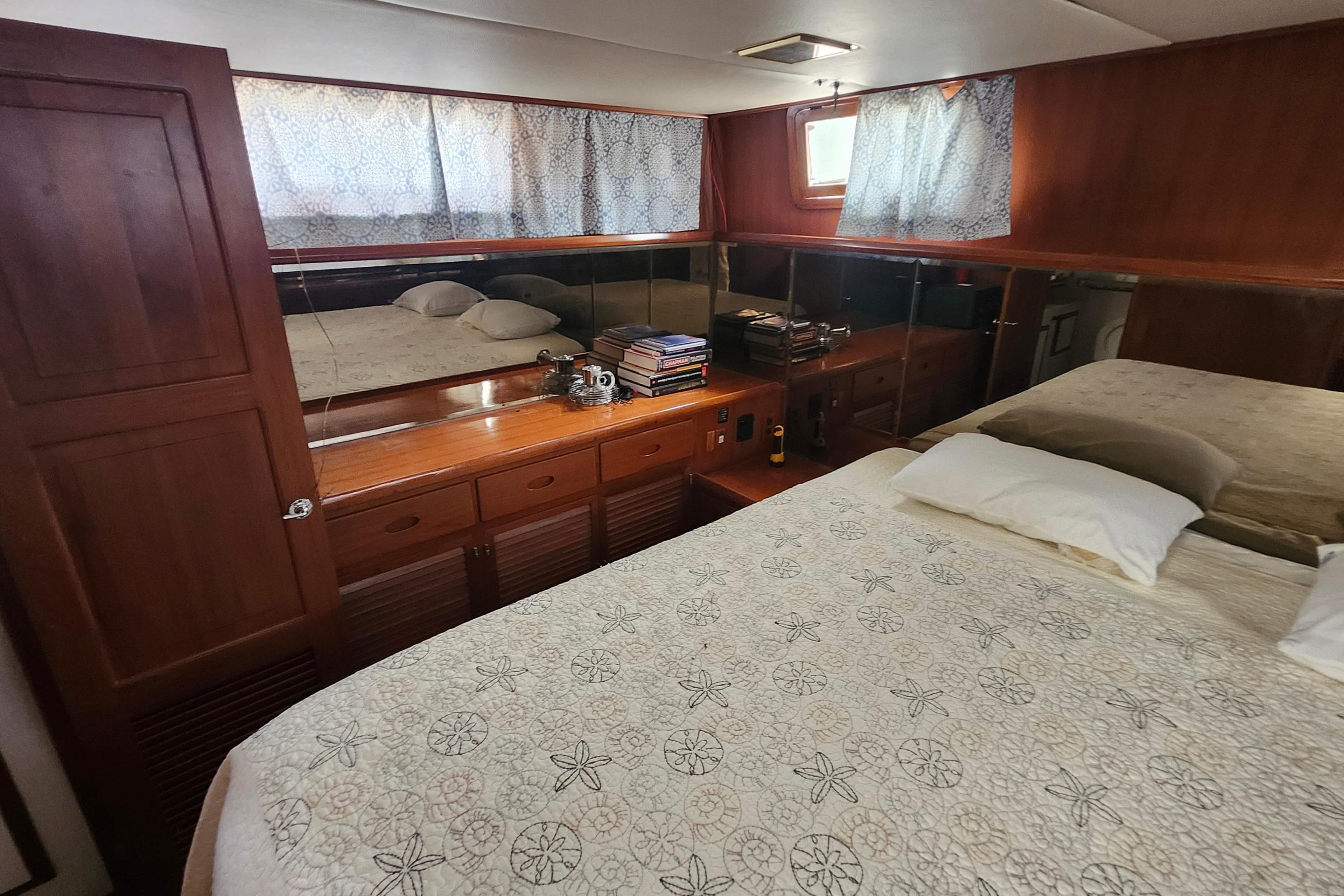 Luxurious cabin interior of 1988 Marine Trader 43 yacht with elegant wood finish.