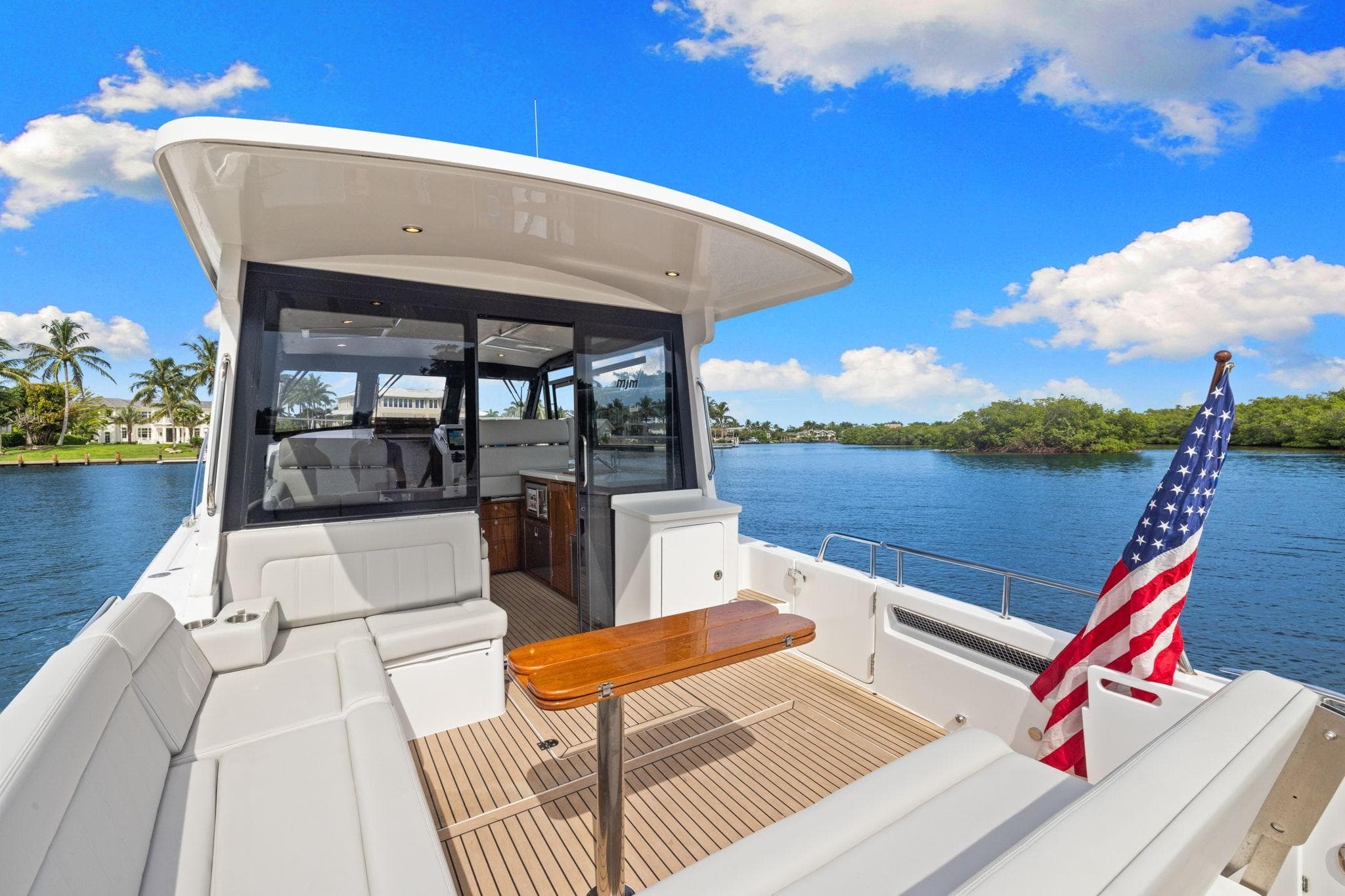 2024 MJM 42 yacht interior with American flag, docked on a sunny day.