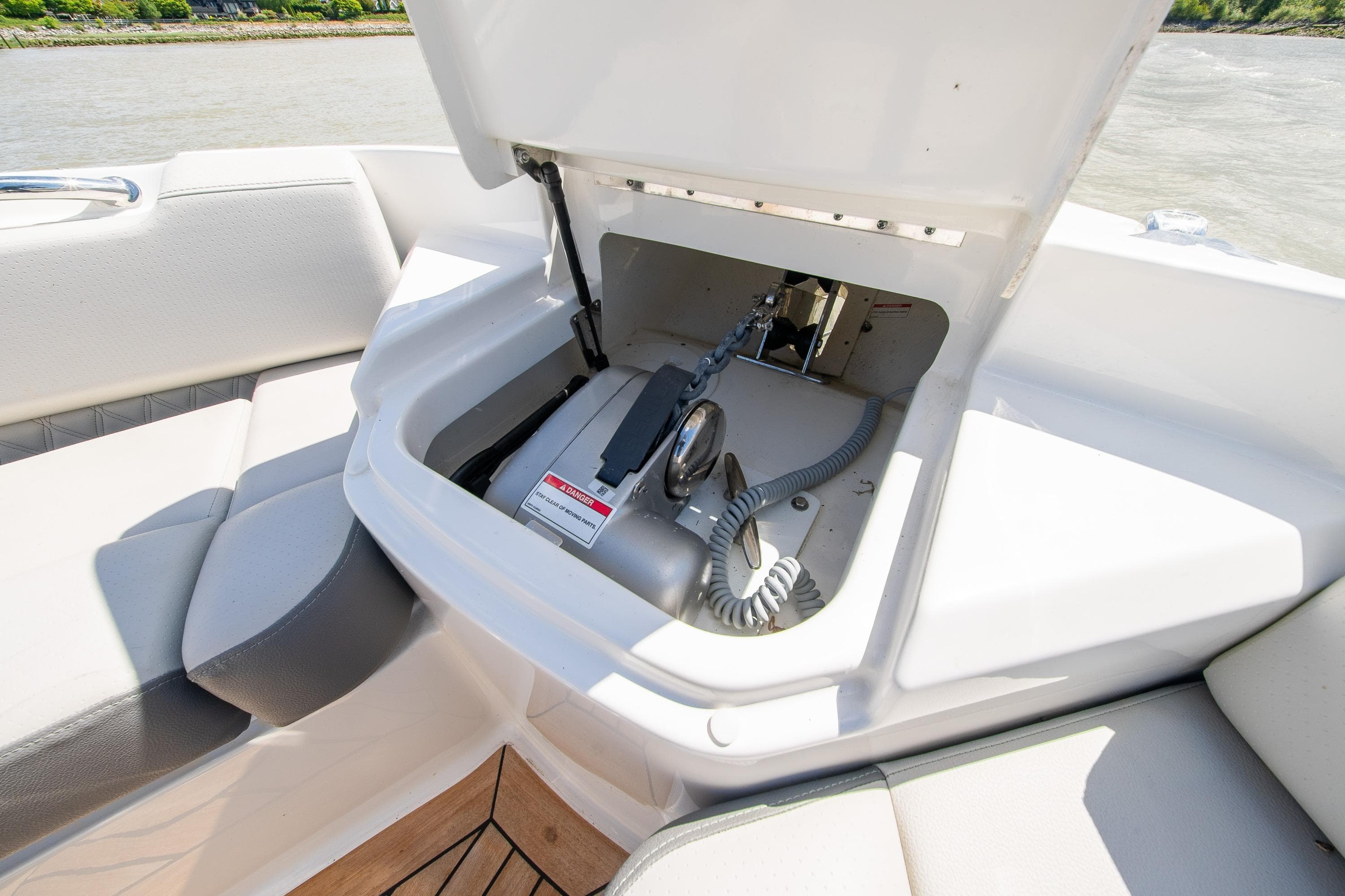 2023 Sea Ray SLX 400 boat storage compartment with open hatch, showcasing interior details.