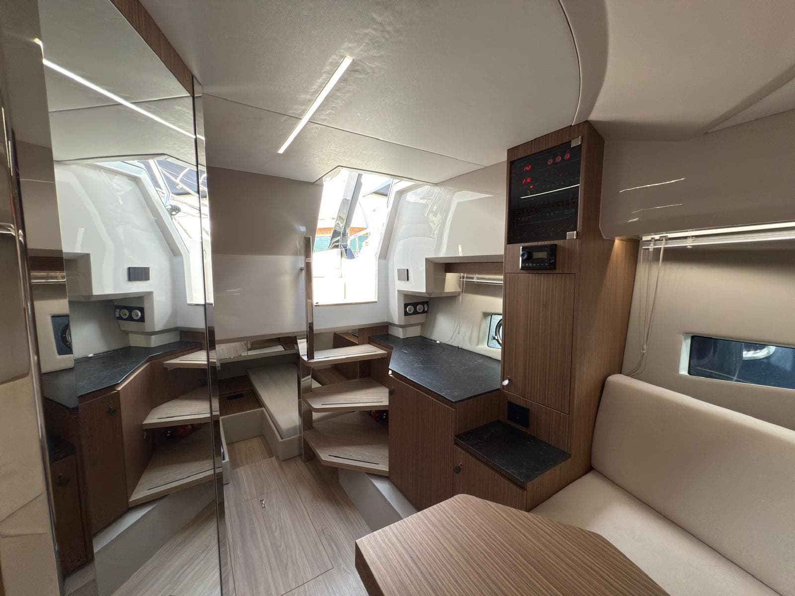 Luxurious interior of 2024 FIM 340 yacht with modern wood finishes and ample natural light.