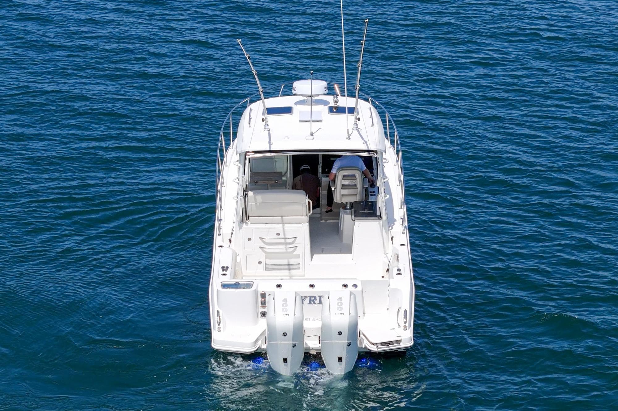 2024 Boston Whaler 325 Conquest boat on open water, rear view.
