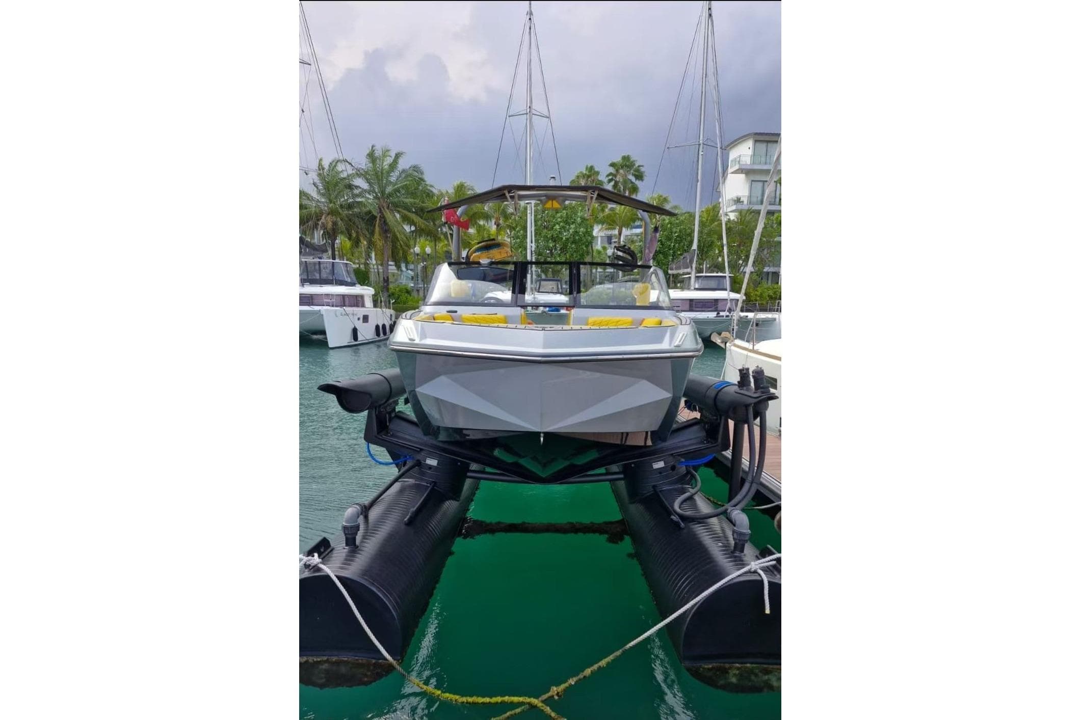 2022 Nautique Super Air Nautique G25 boat docked at marina with palm trees.