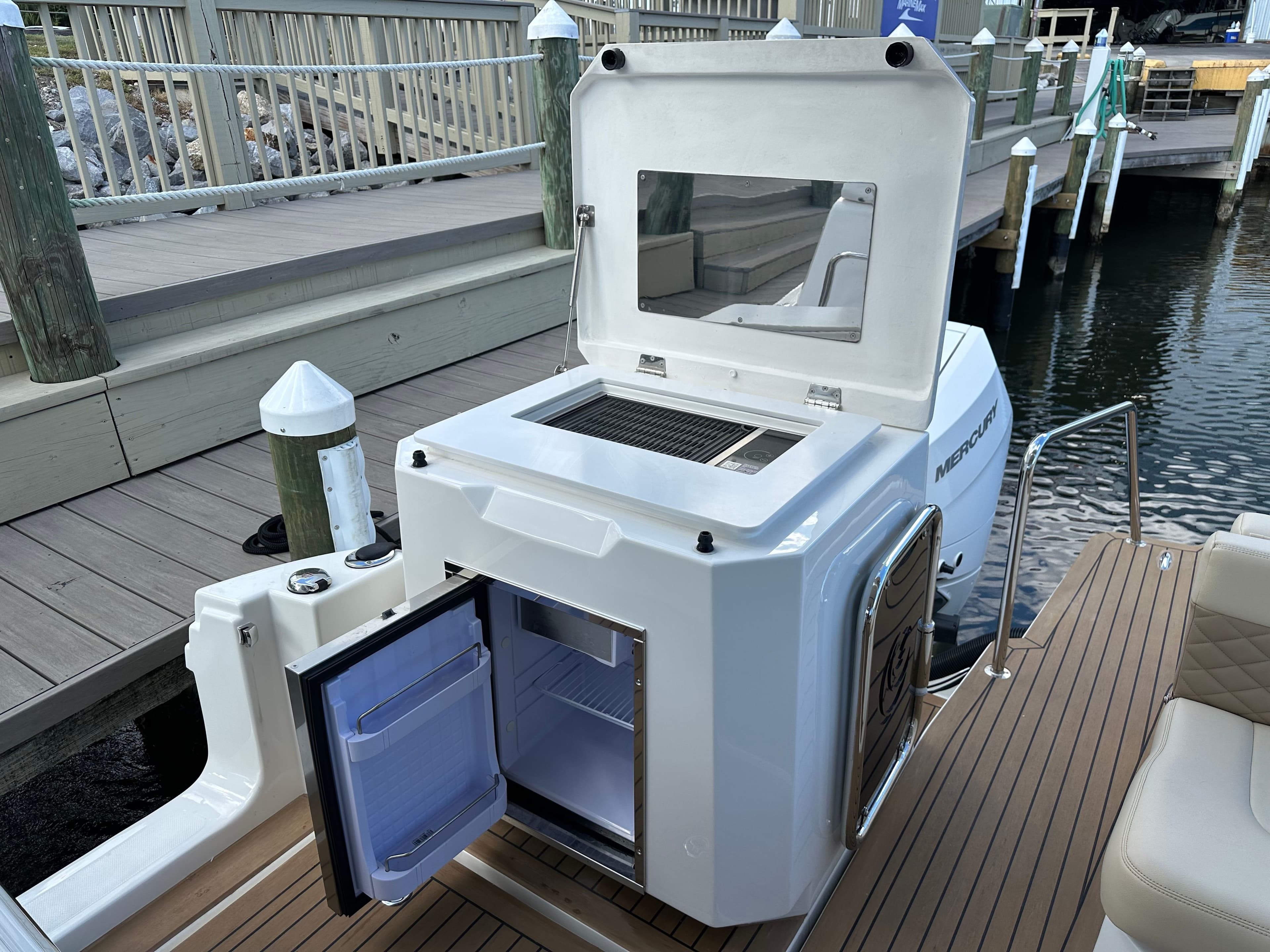 Aquila 36 Sport 2025 boat with open fridge and grill on deck.