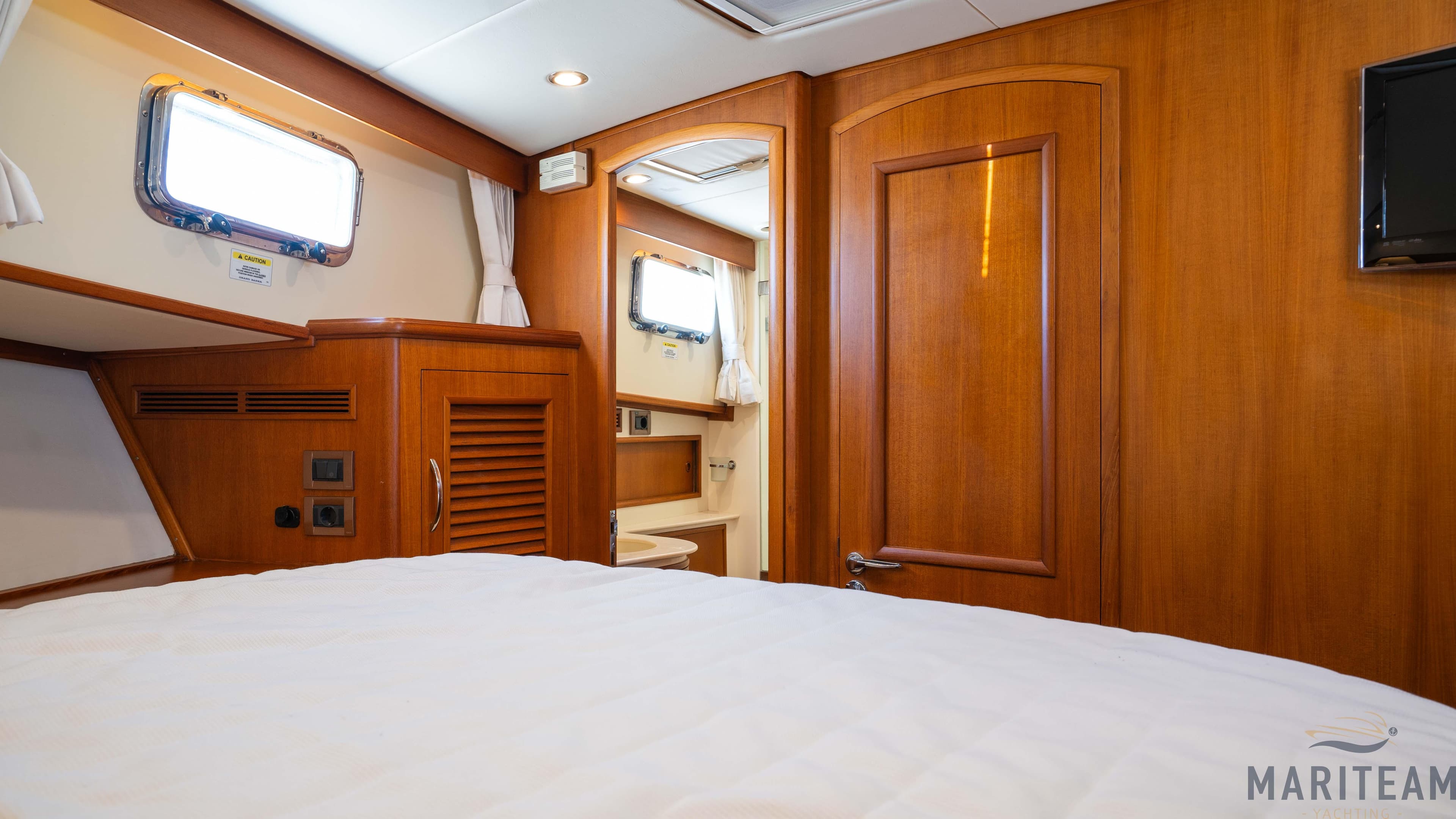 Luxurious cabin interior of 2011 Grand Banks 41 Heritage EU yacht with wooden finishes.