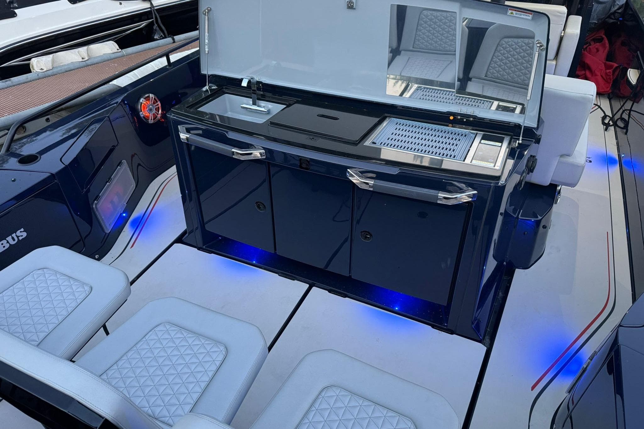 2022 Axopar Brabus Shadow 900 Sun-Top boat interior with sleek kitchen setup.