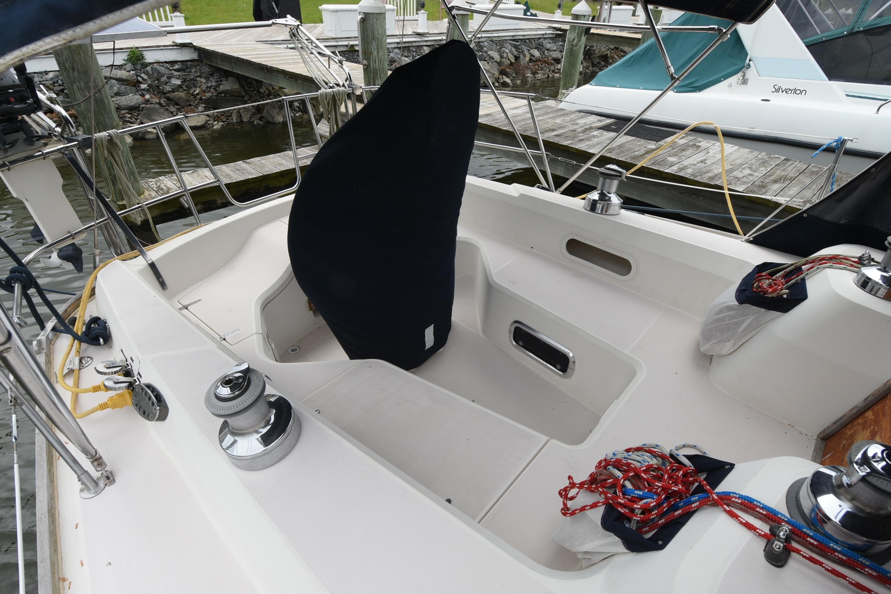 Cockpit of a 1996 Sabre 402 sailboat with winches and ropes, docked at a marina.