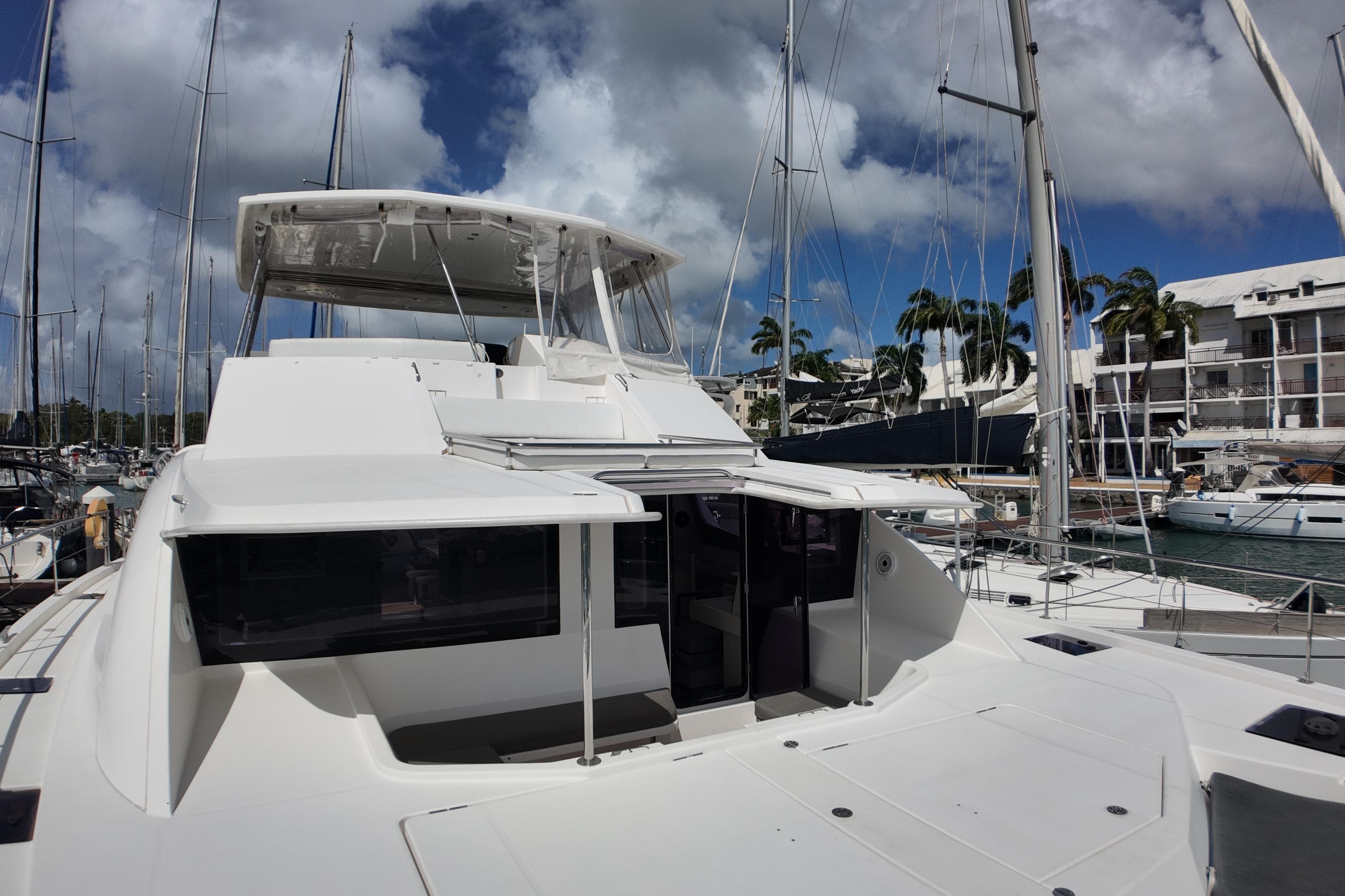 2017 Leopard 51 Powercat yacht docked at marina under cloudy sky.